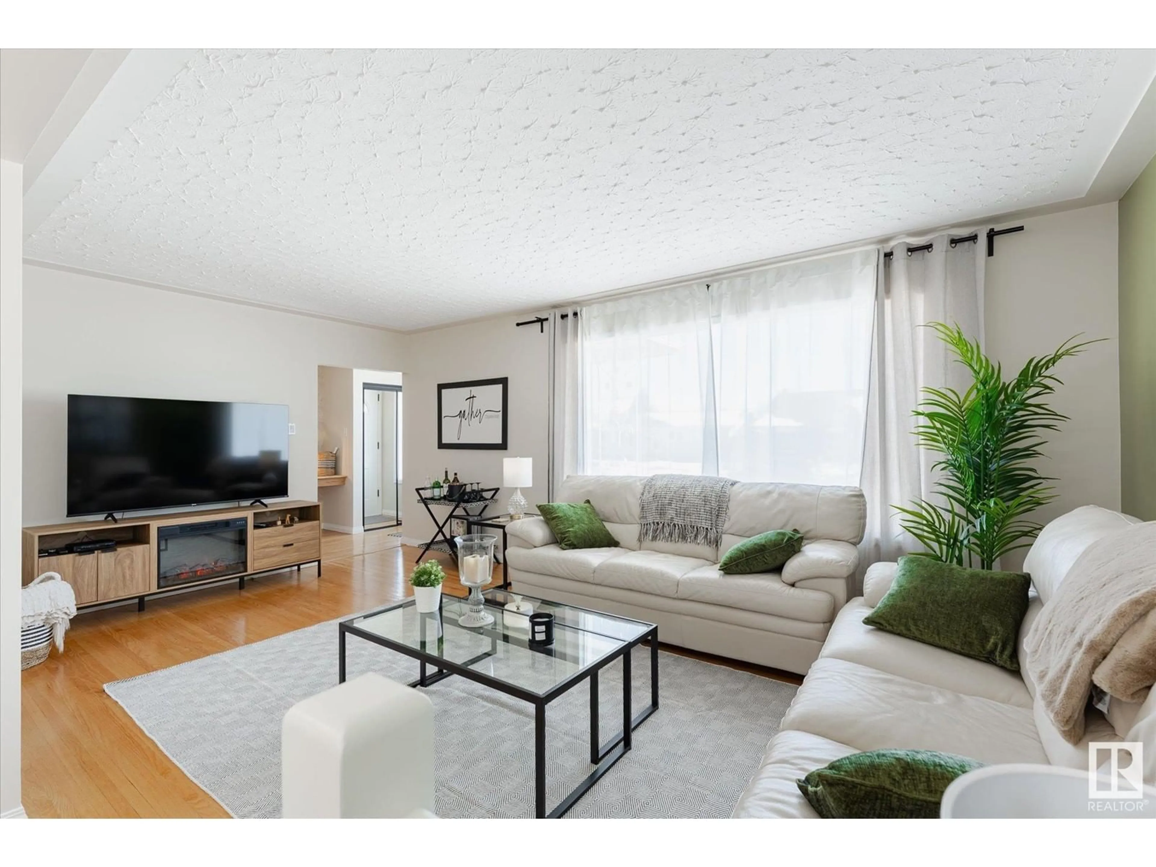 Living room with furniture, wood/laminate floor for NW - 8416 56 ST, Edmonton Alberta T6B1H7