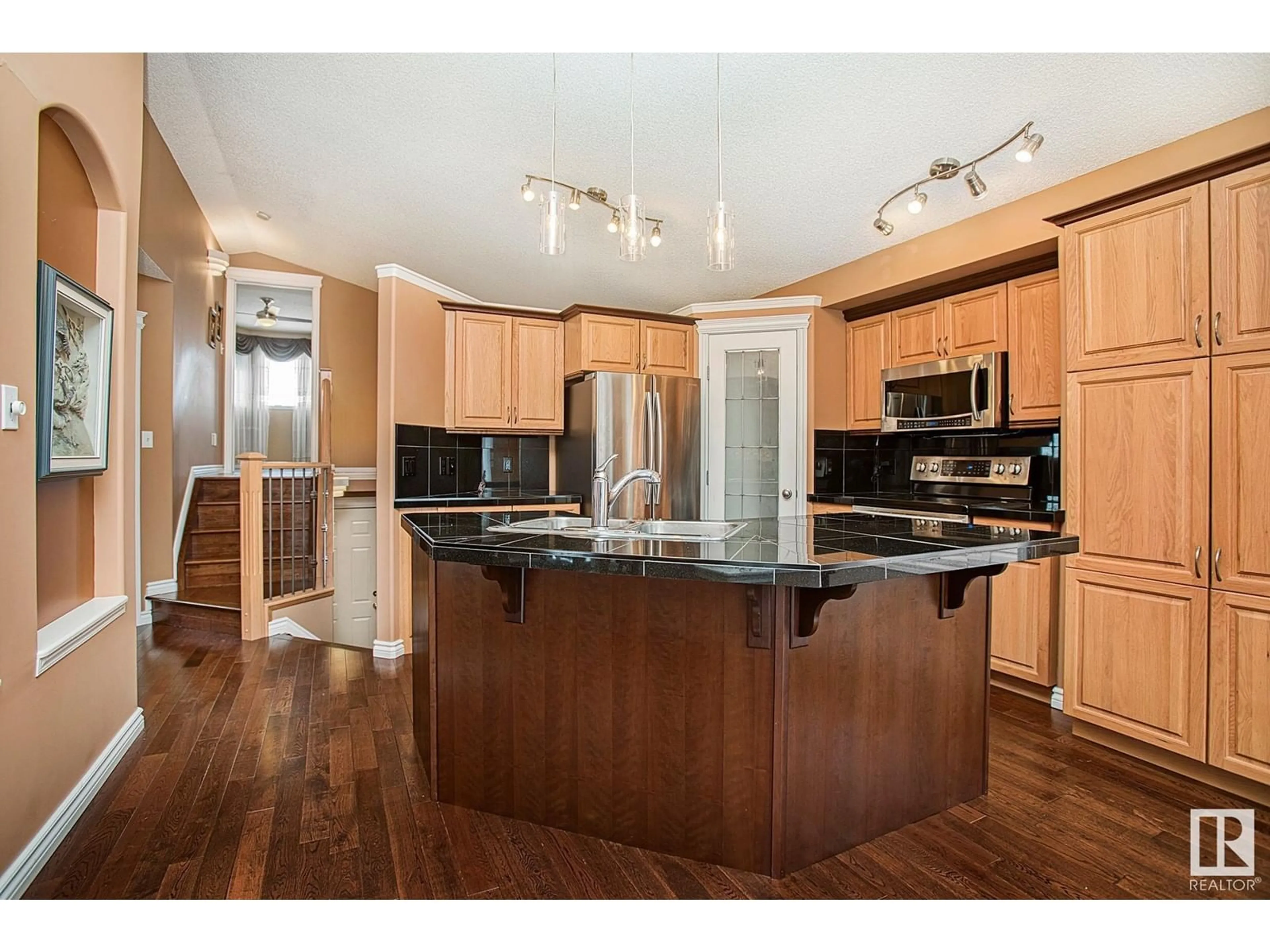 Open concept kitchen, wood/laminate floor for 3760 23 ST, Edmonton Alberta T6T1P4