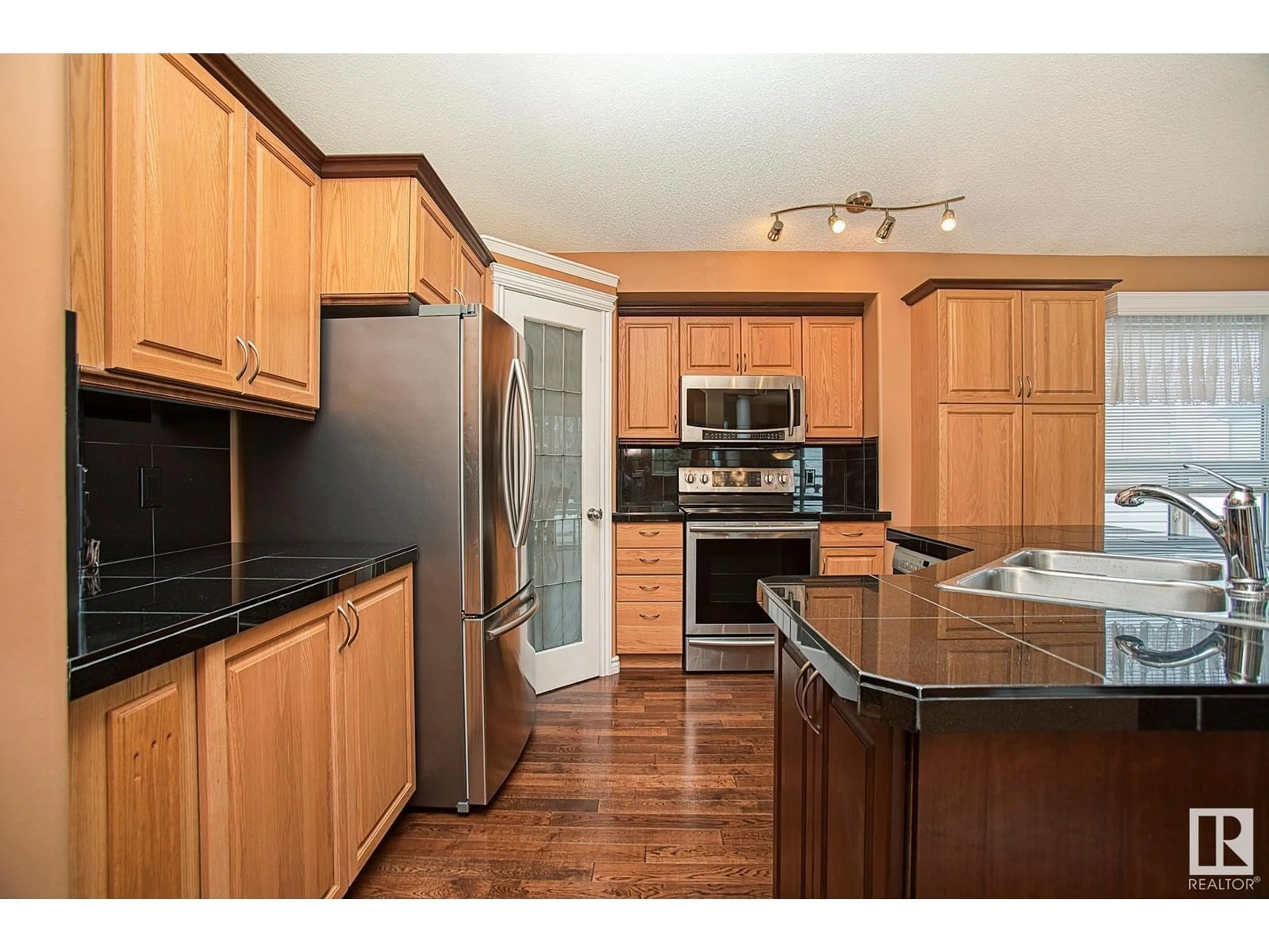 Open concept kitchen, wood/laminate floor for 3760 23 ST, Edmonton Alberta T6T1P4