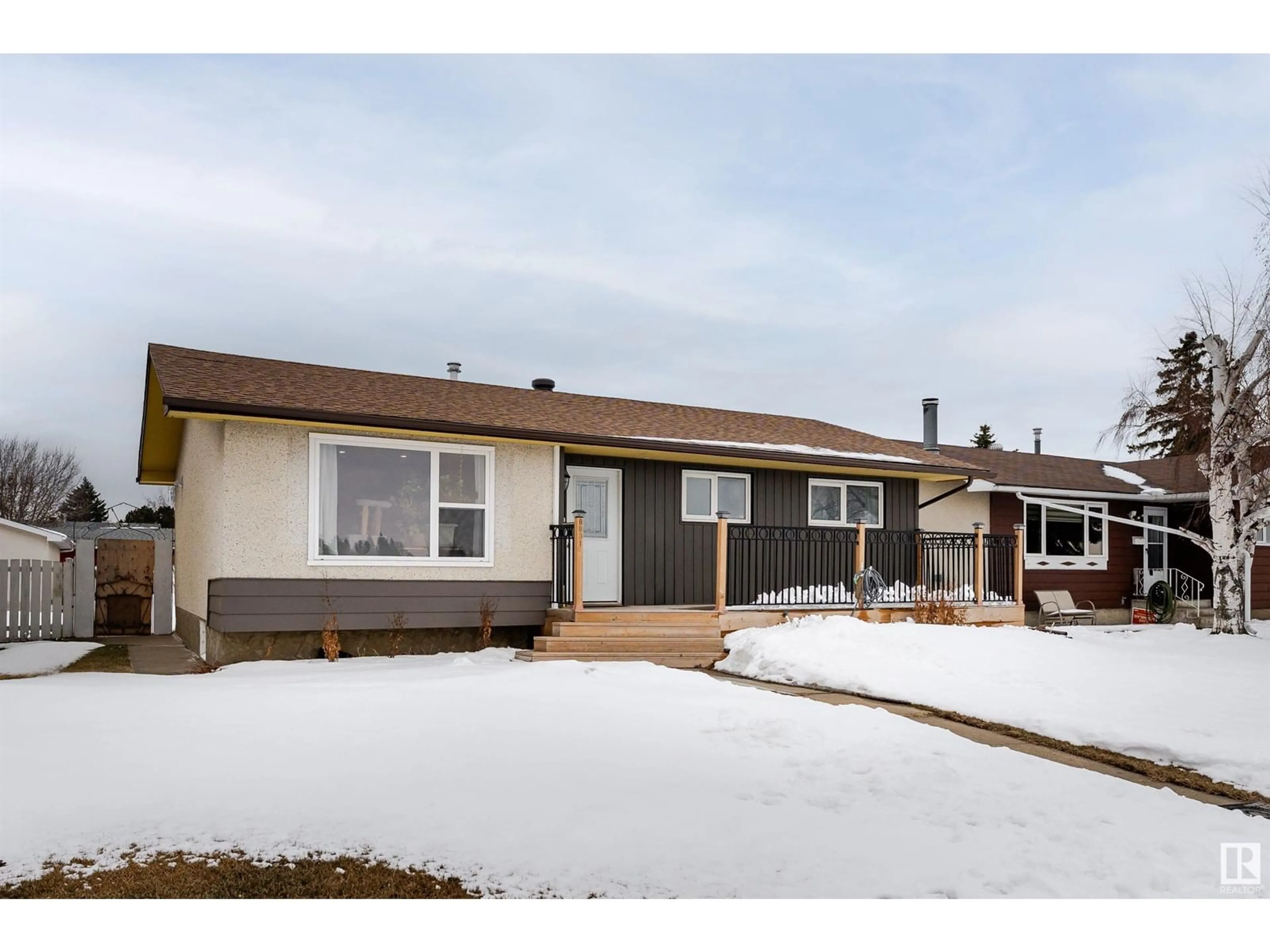 Home with vinyl exterior material, street for 8831 140 AV, Edmonton Alberta T5E2C8