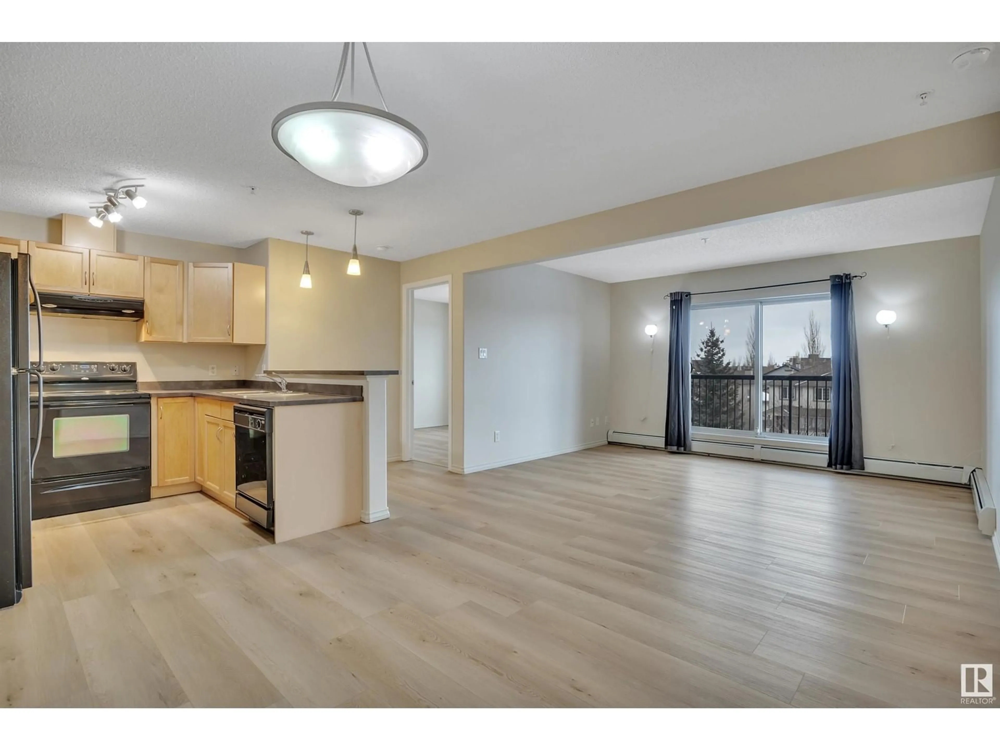 Open concept kitchen, wood/laminate floor for #311 - 646 MCALLISTER LO, Edmonton Alberta T6W0B5