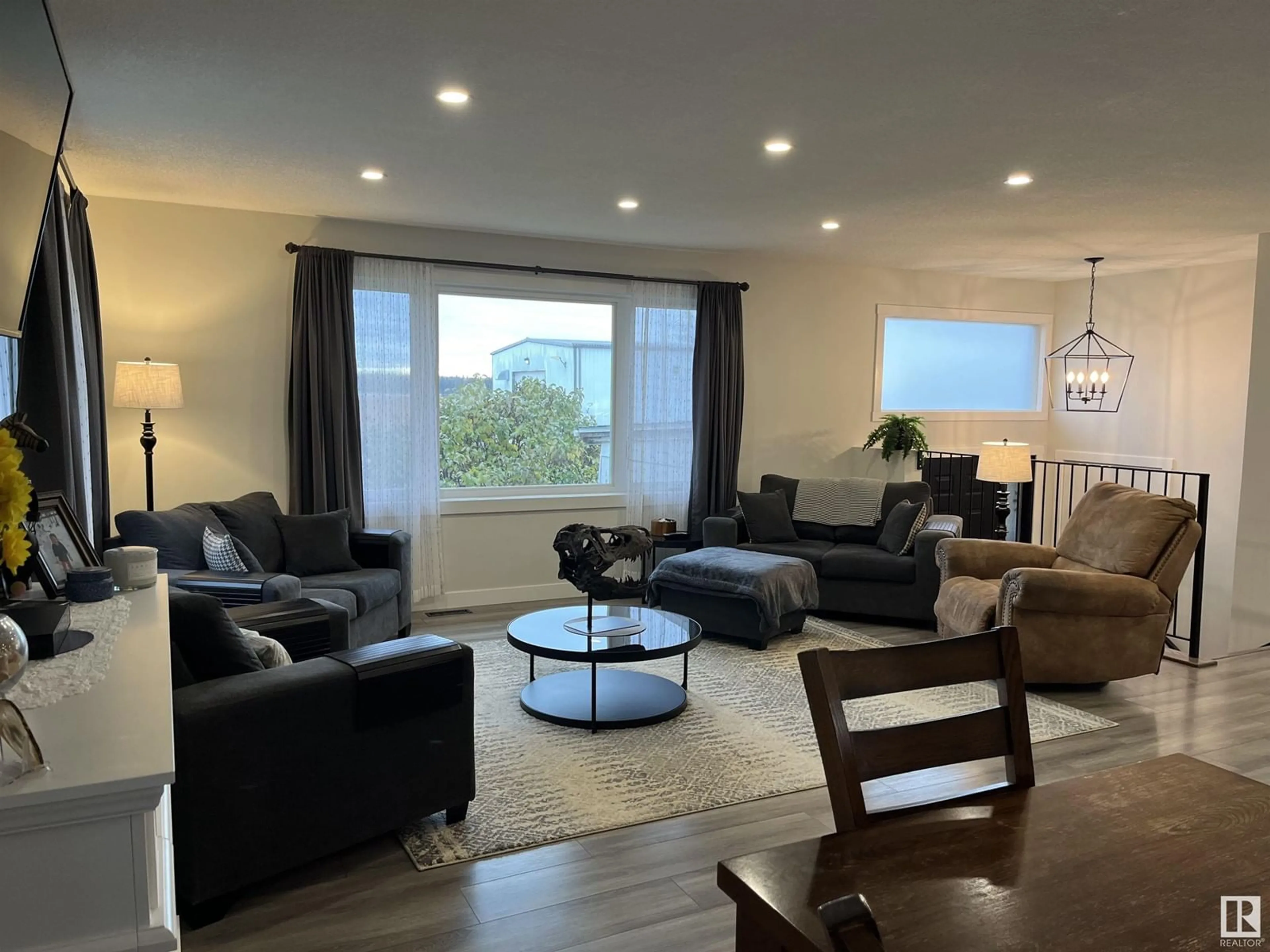 Living room with furniture, wood/laminate floor for 55502 NIKOODI RD, Rural Lac Ste. Anne County Alberta T0E0X0
