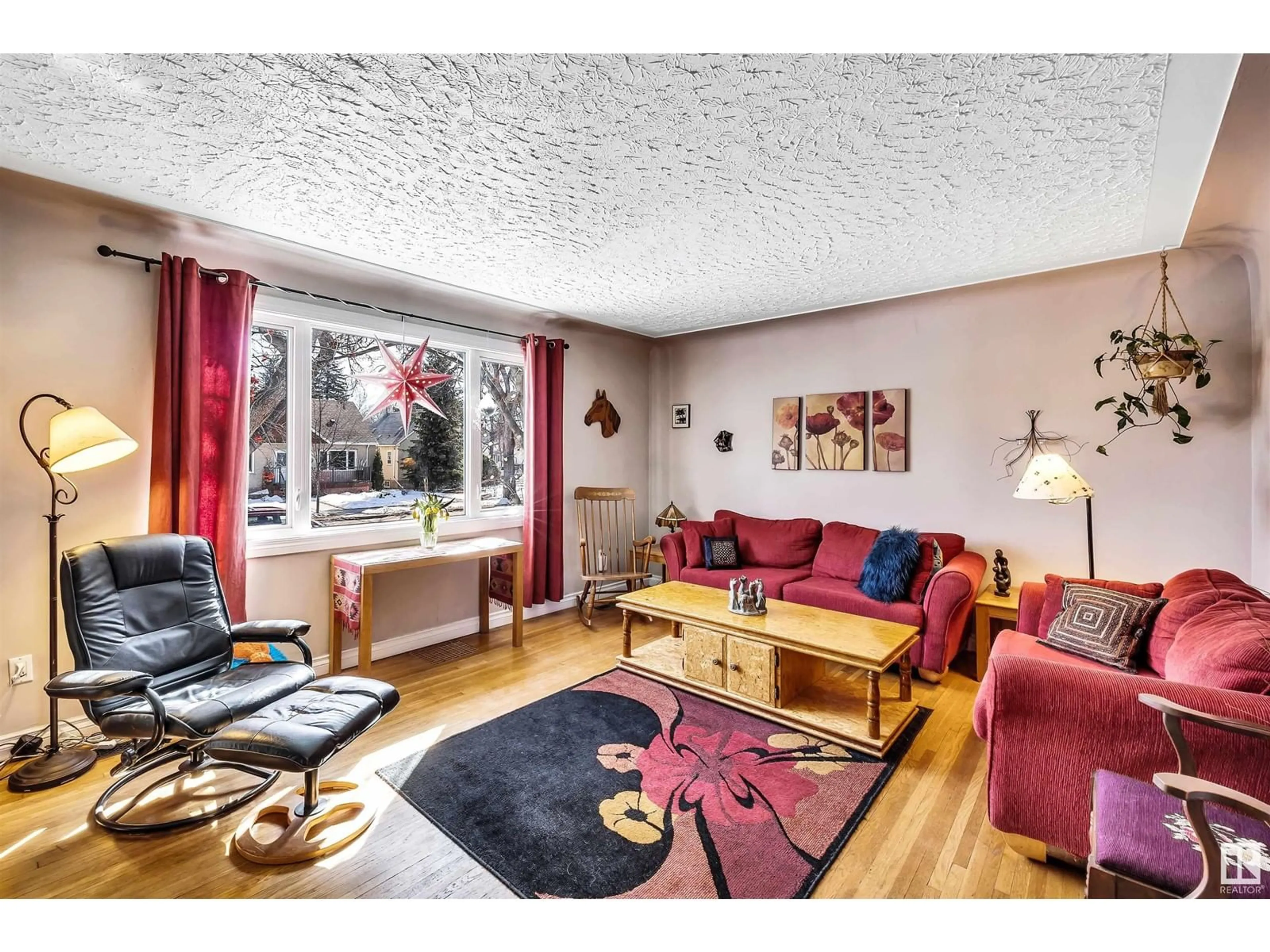 Living room with furniture, wood/laminate floor for 10962 135 ST NW, Edmonton Alberta T5M1K2