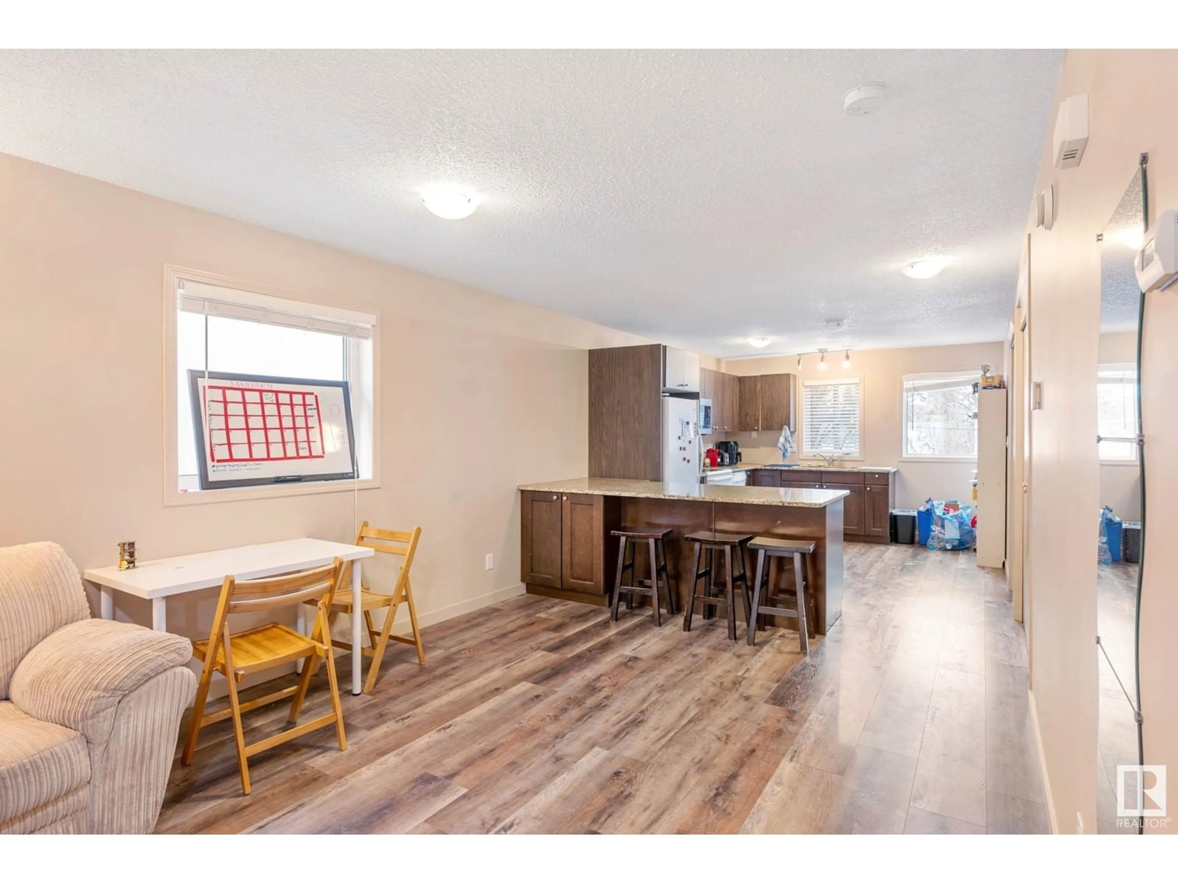 Open concept kitchen, wood/laminate floor for NW - 7712 110 ST, Edmonton Alberta T6G1G1