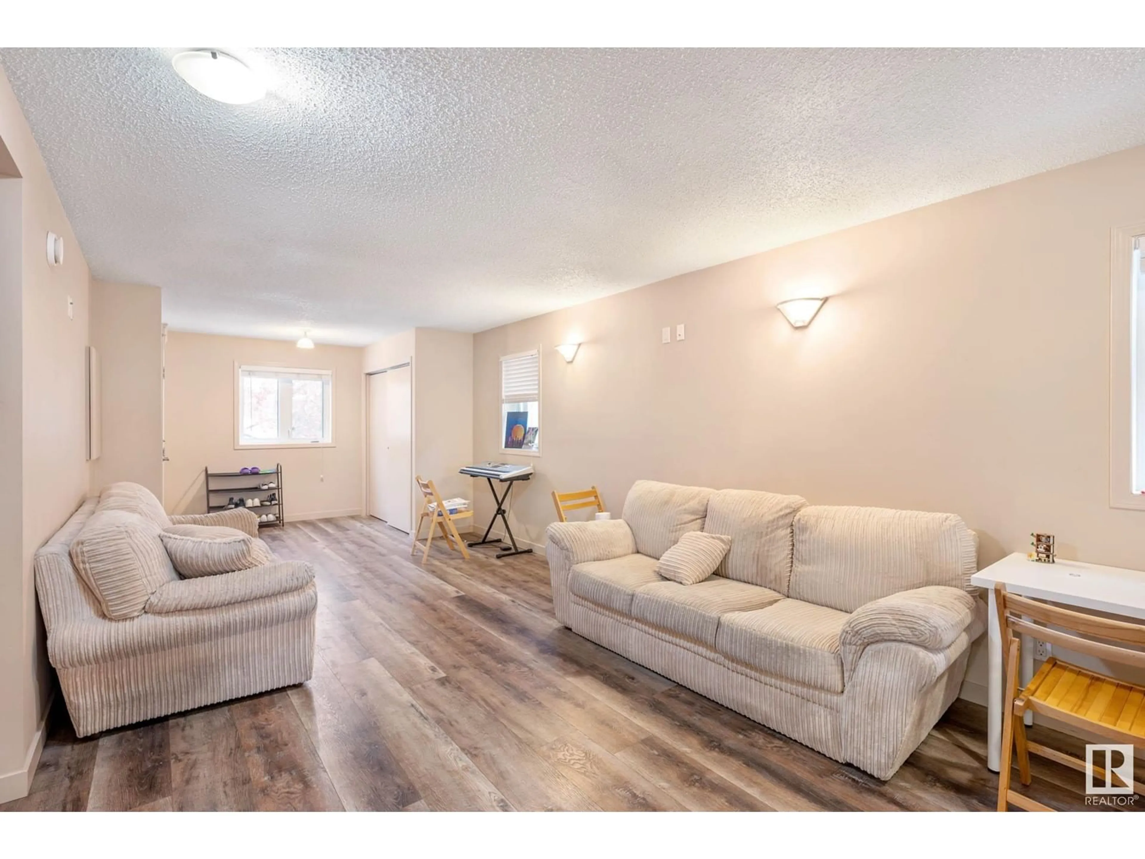 Living room with furniture, wood/laminate floor for NW - 7712 110 ST, Edmonton Alberta T6G1G1