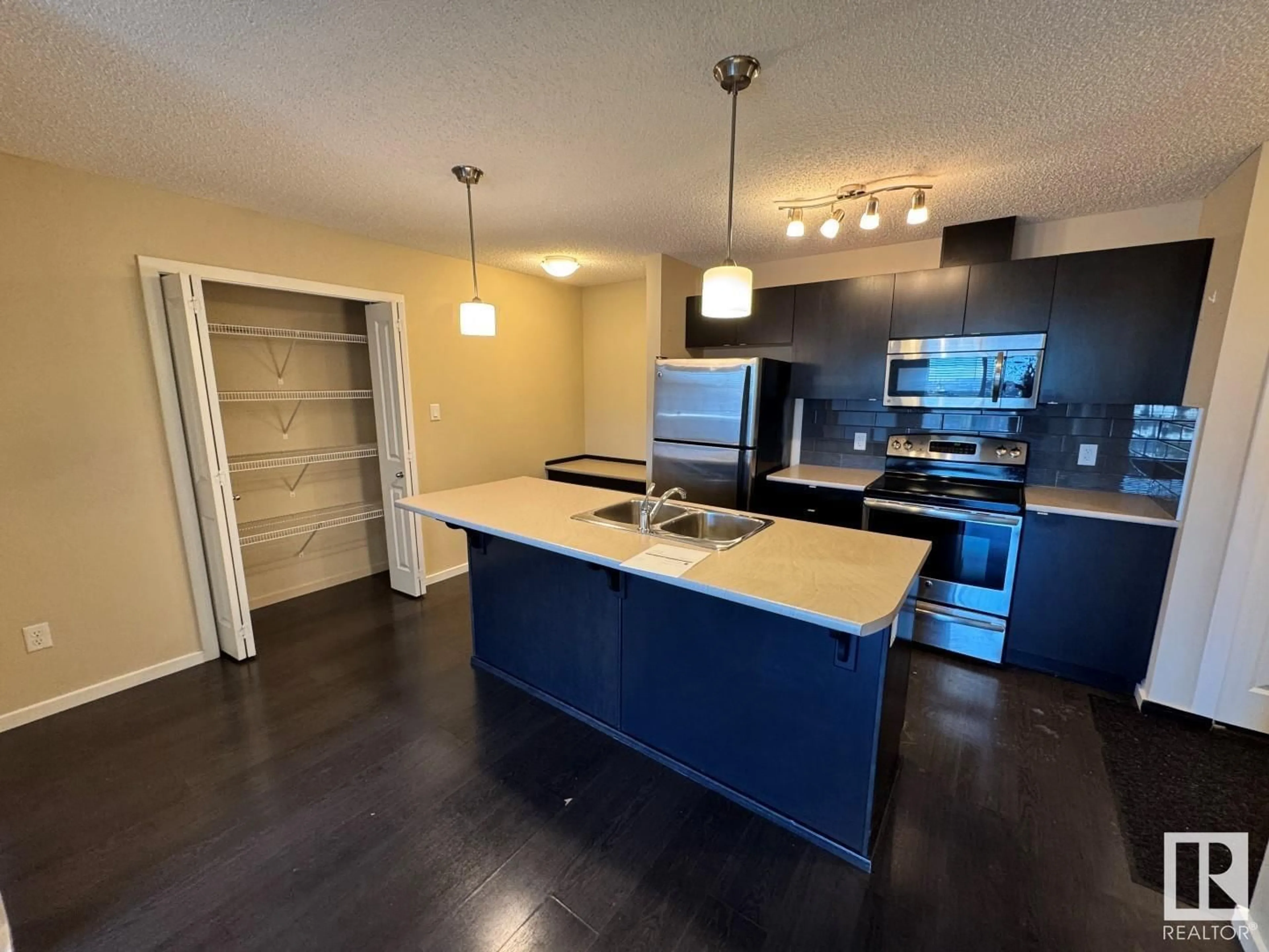 Open concept kitchen, wood/laminate floor for #401 - 508 ALBANY WY, Edmonton Alberta T6V0L1