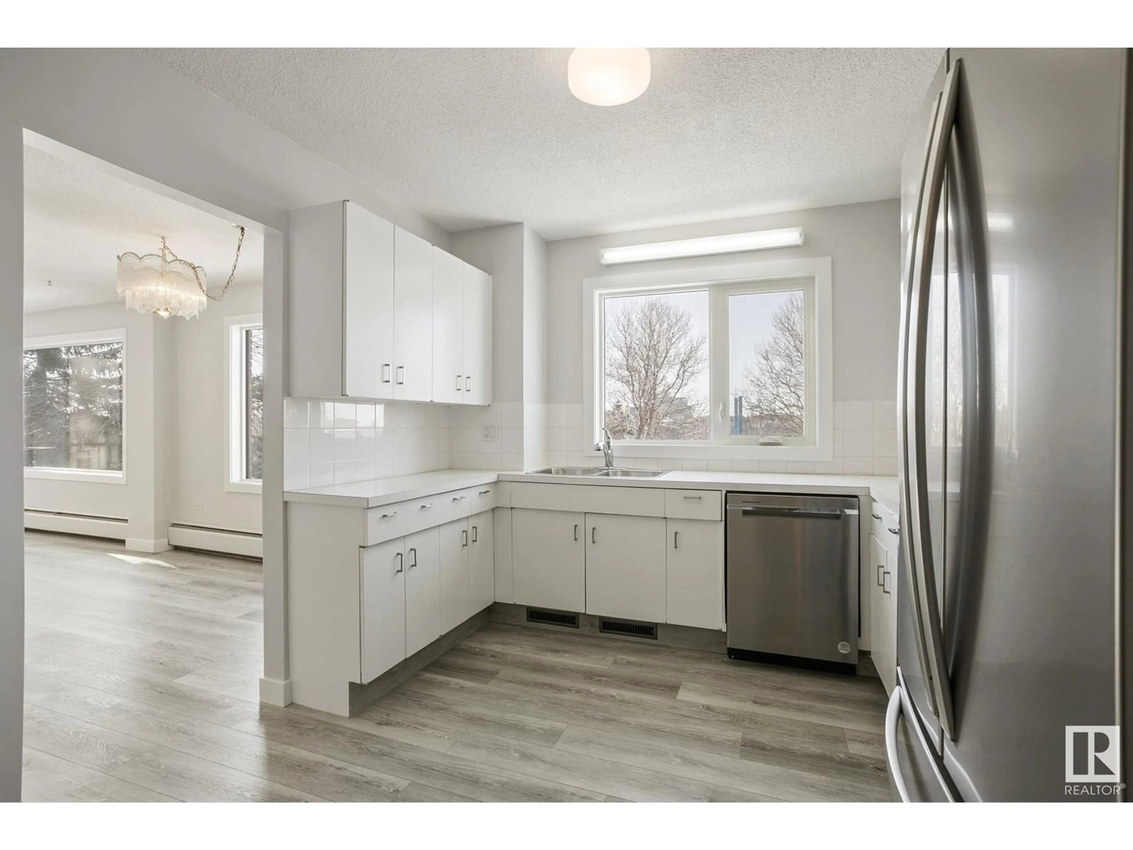 Open concept kitchen, wood/laminate floor for #304 - 10011 117 ST, Edmonton Alberta T5K1W7