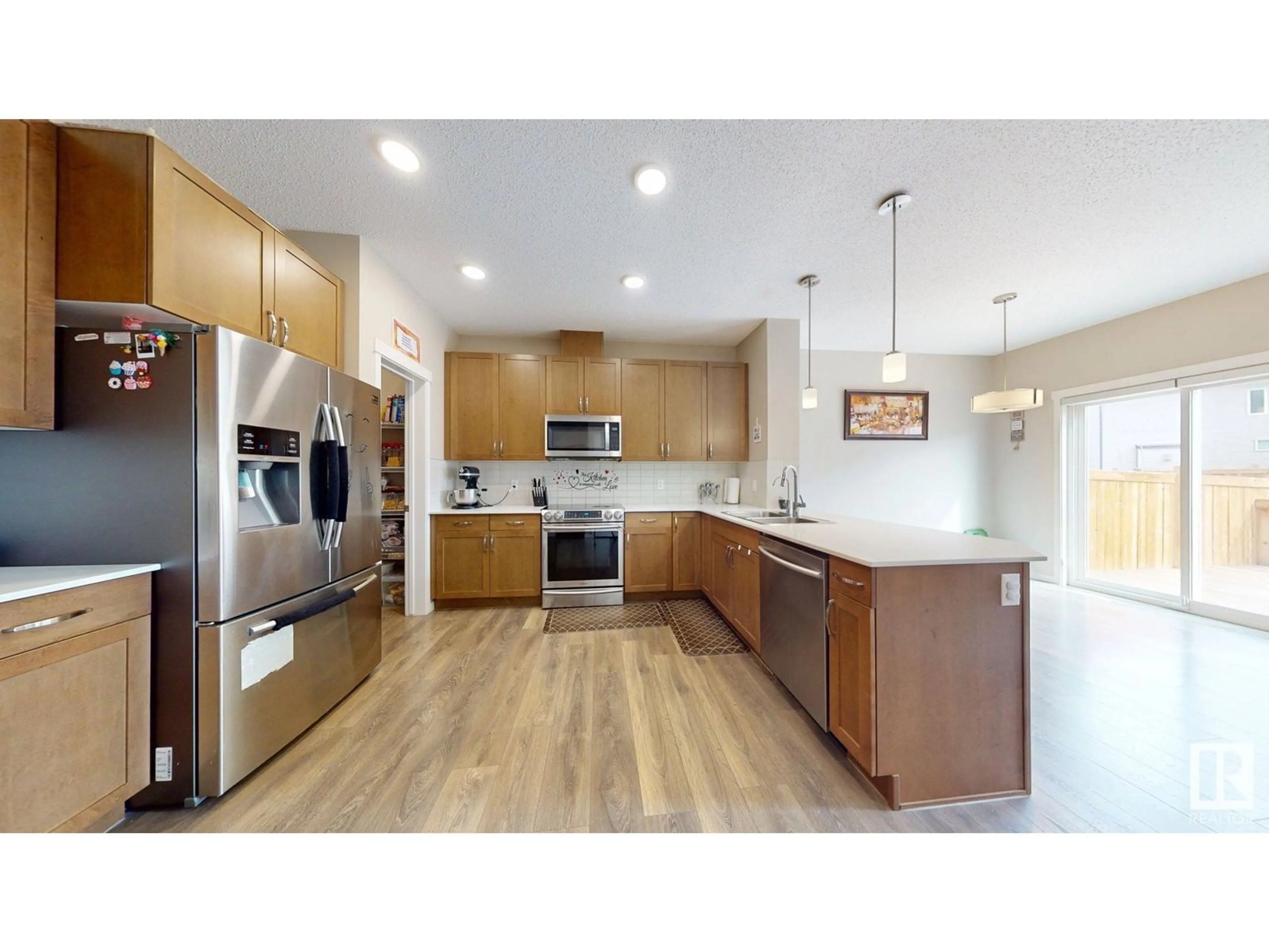 Open concept kitchen, wood/laminate floor for 1303 27 ST, Edmonton Alberta T6T0K1
