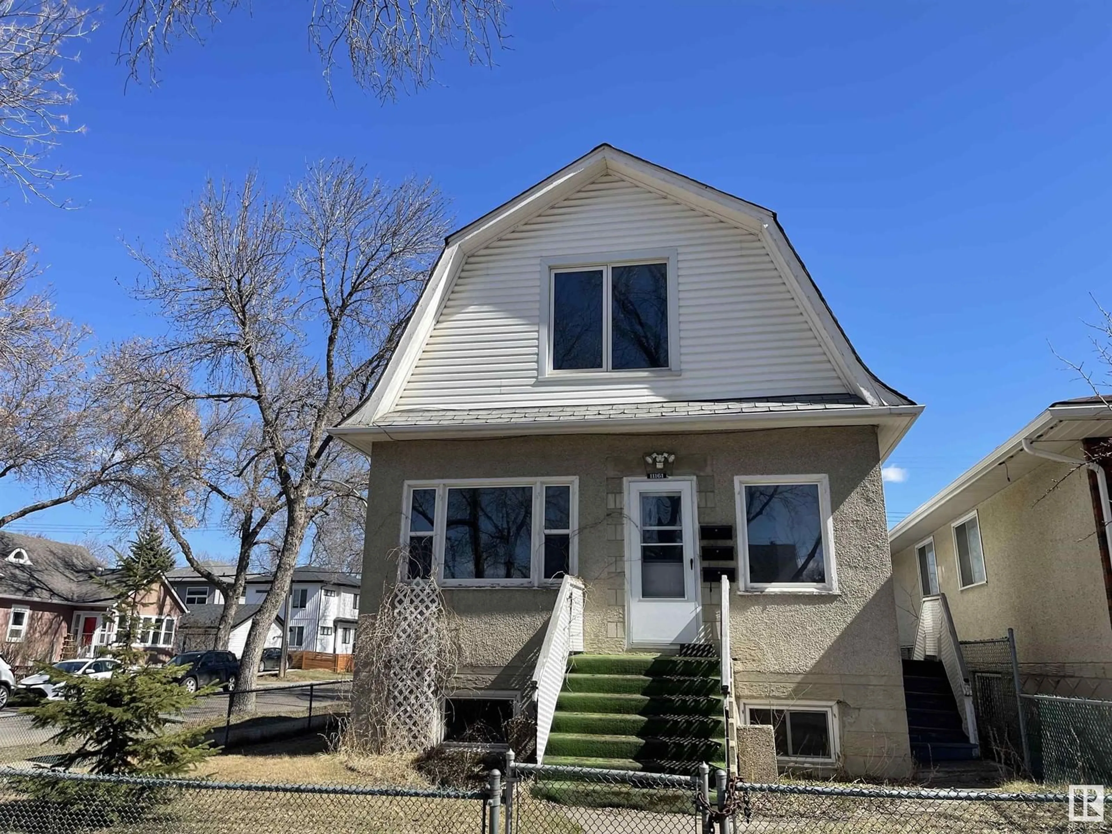 Home with vinyl exterior material, street for 11161 96 ST, Edmonton Alberta T5G1S8