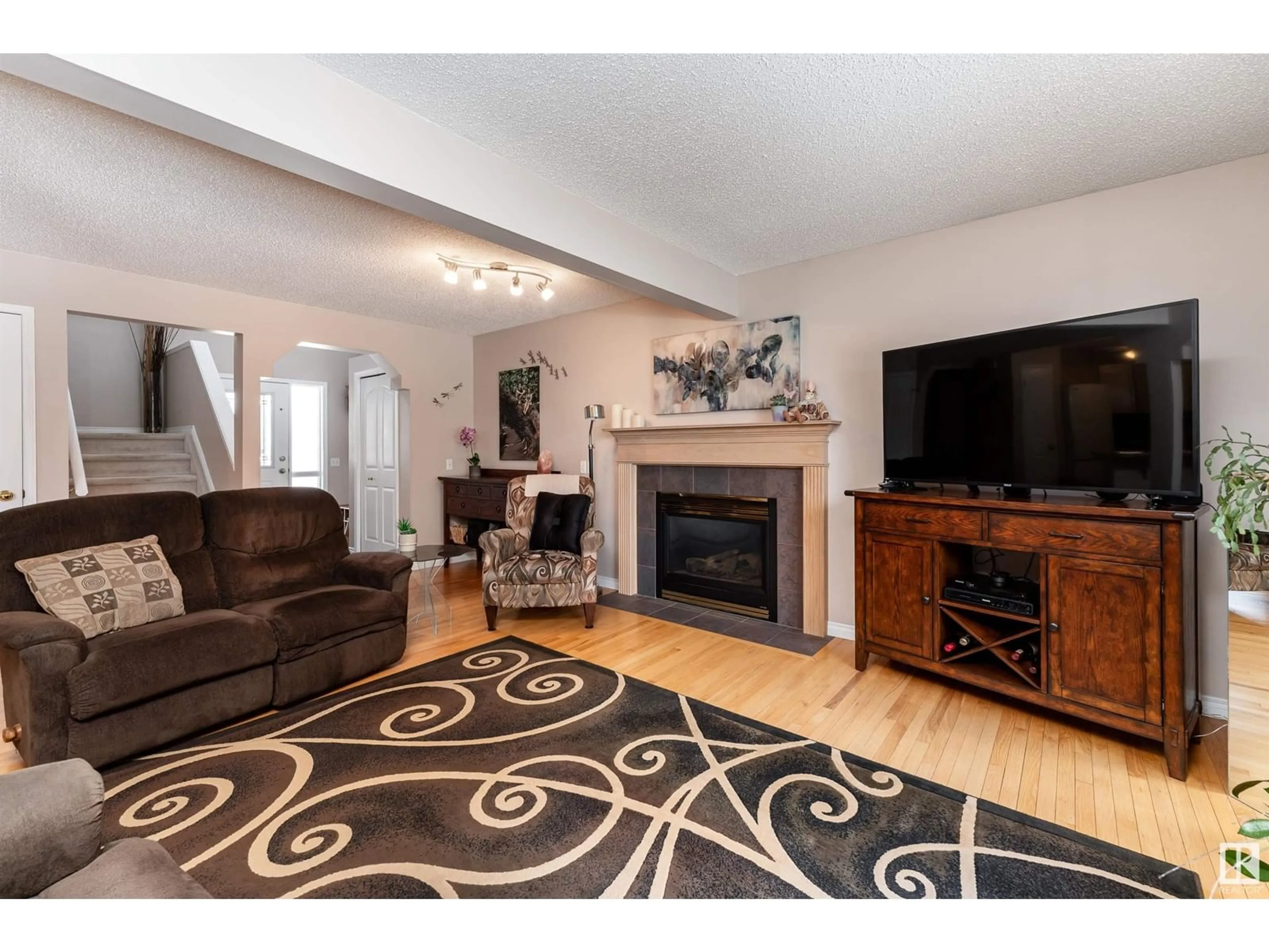 Living room with furniture, wood/laminate floor for NW - 8823 188 ST, Edmonton Alberta T5T5Z8