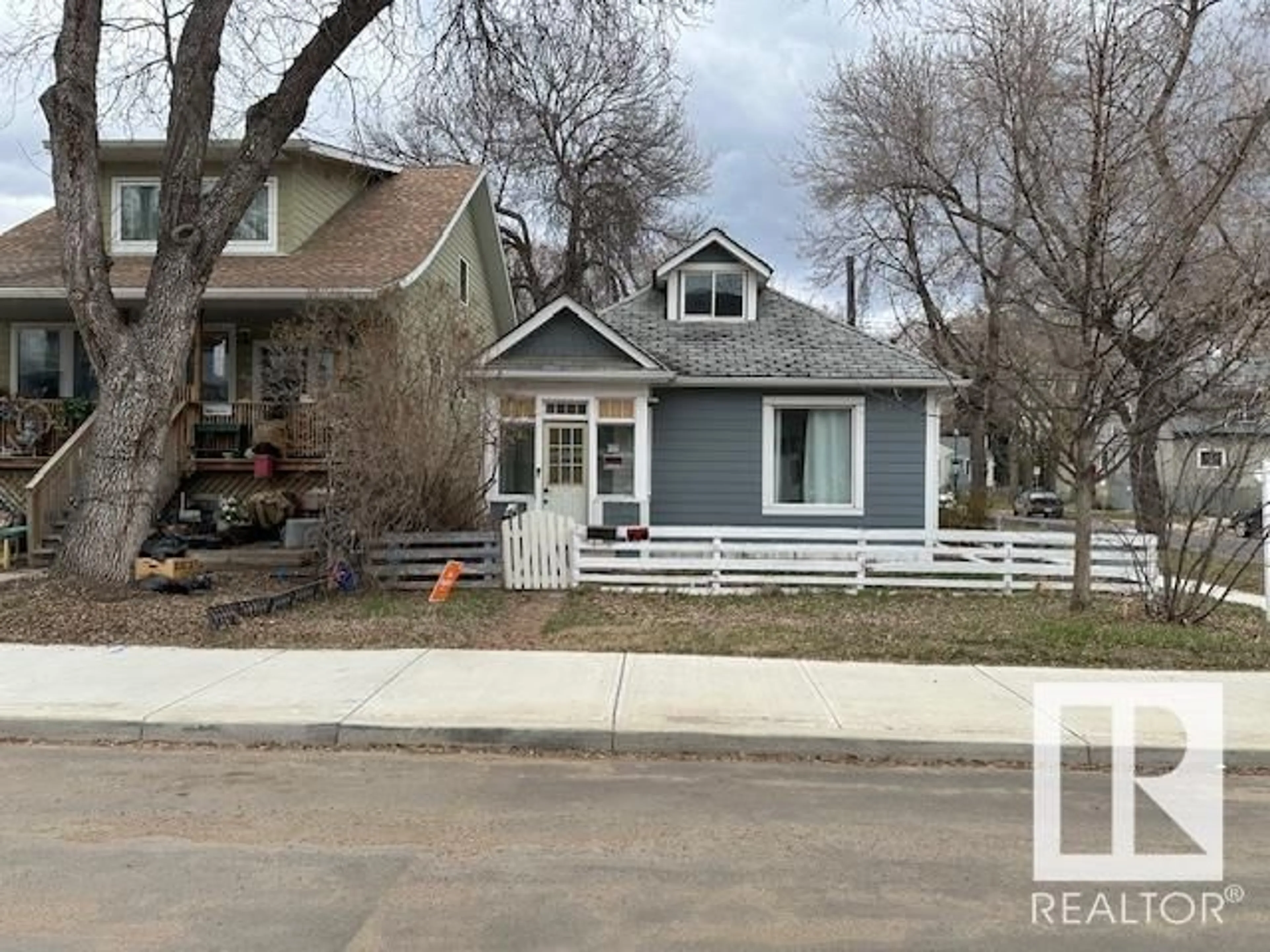 Home with vinyl exterior material, street for NW - 10803 93 ST, Edmonton Alberta T5H1Y7