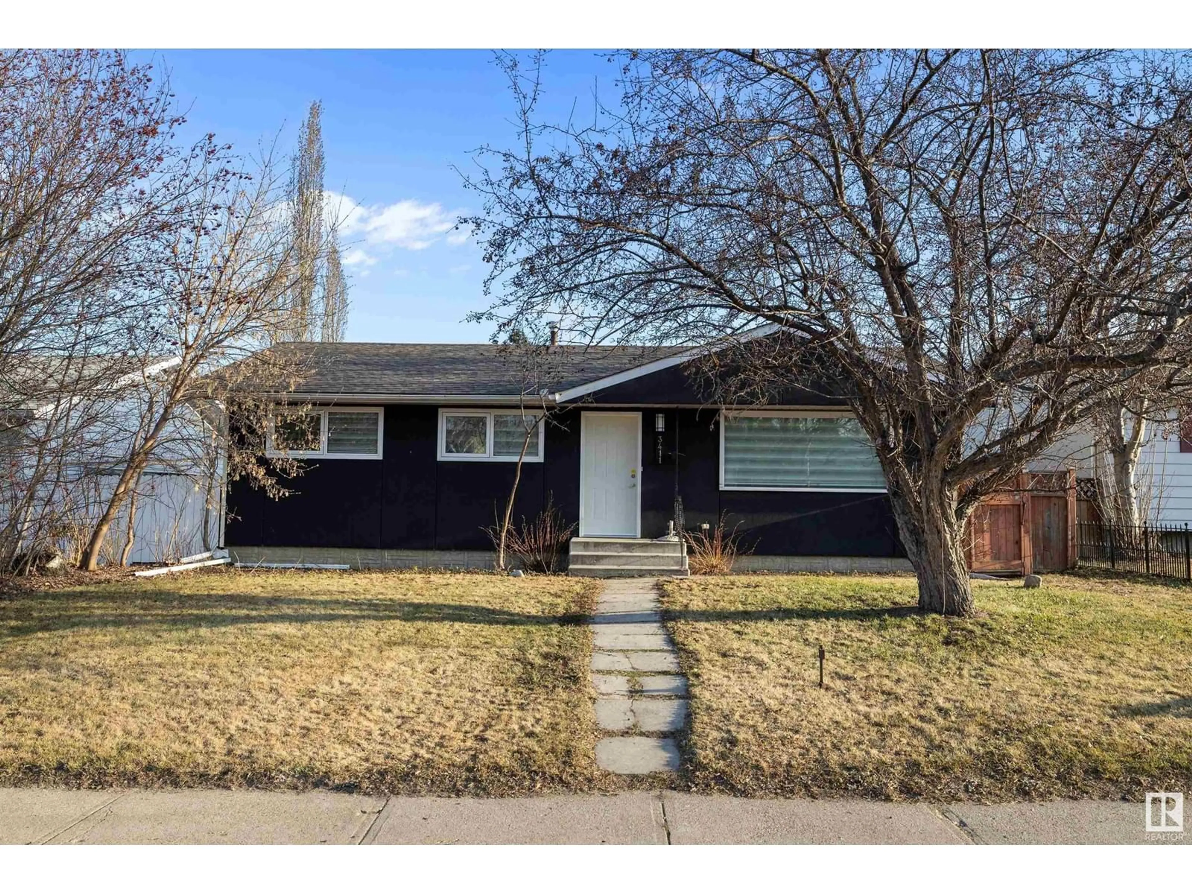 Home with vinyl exterior material, street for 3411 105 AV, Edmonton Alberta T5W0B6