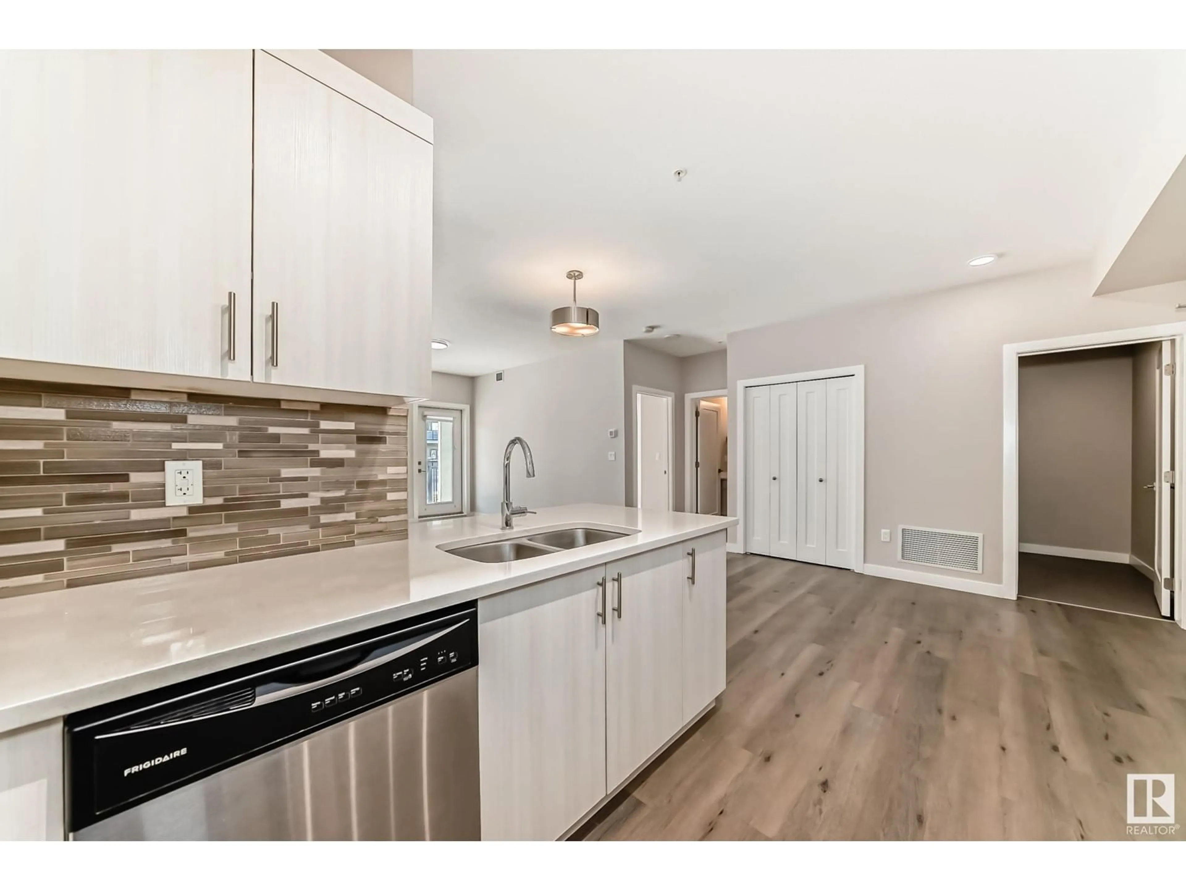 Open concept kitchen, wood/laminate floor for 560 - 126 GRIESBACH PARADE PR, Edmonton Alberta T5E6X1