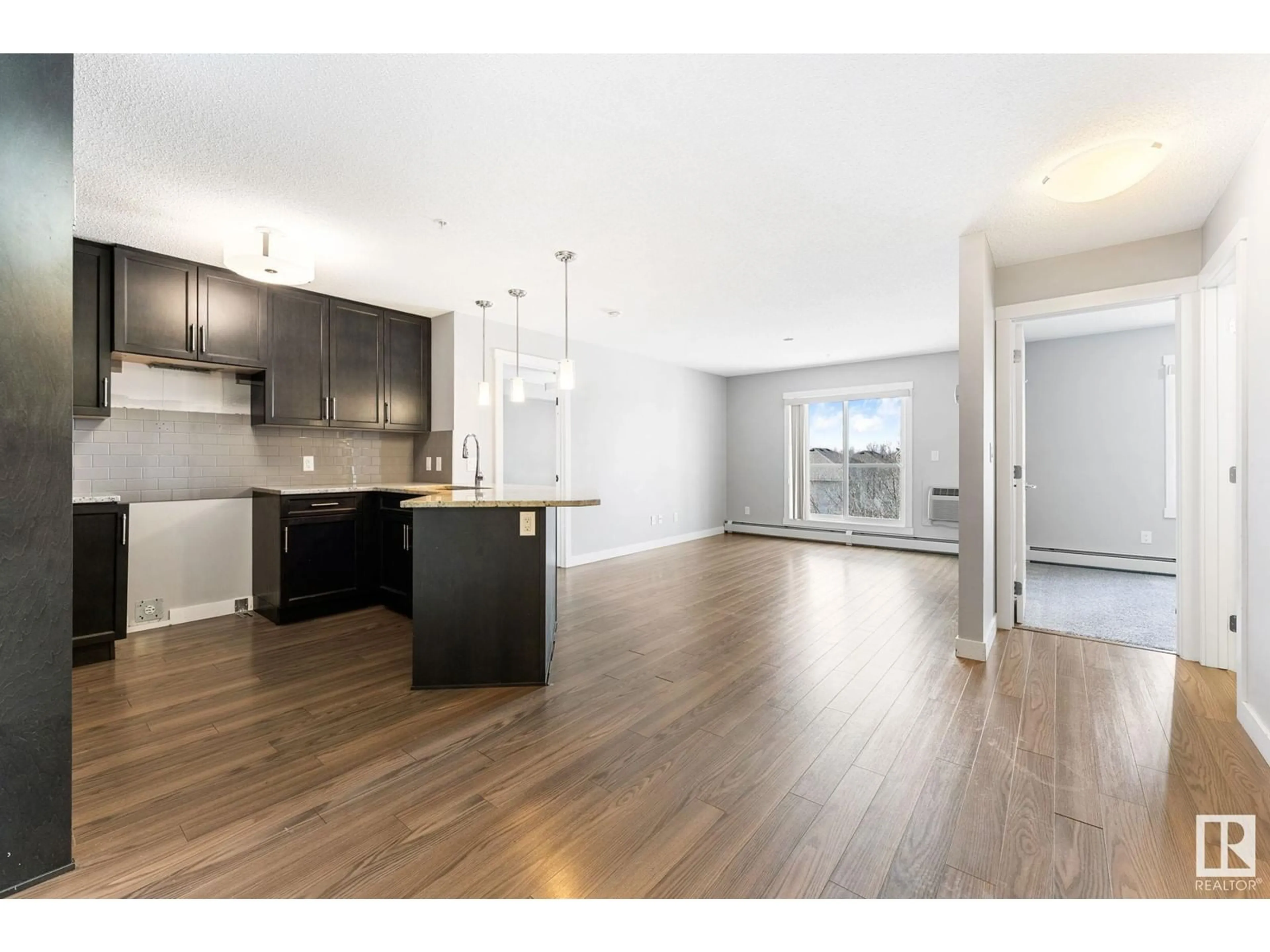 Open concept kitchen, wood/laminate floor for #303 - 2229 44 AV NW, Edmonton Alberta T5T0W6
