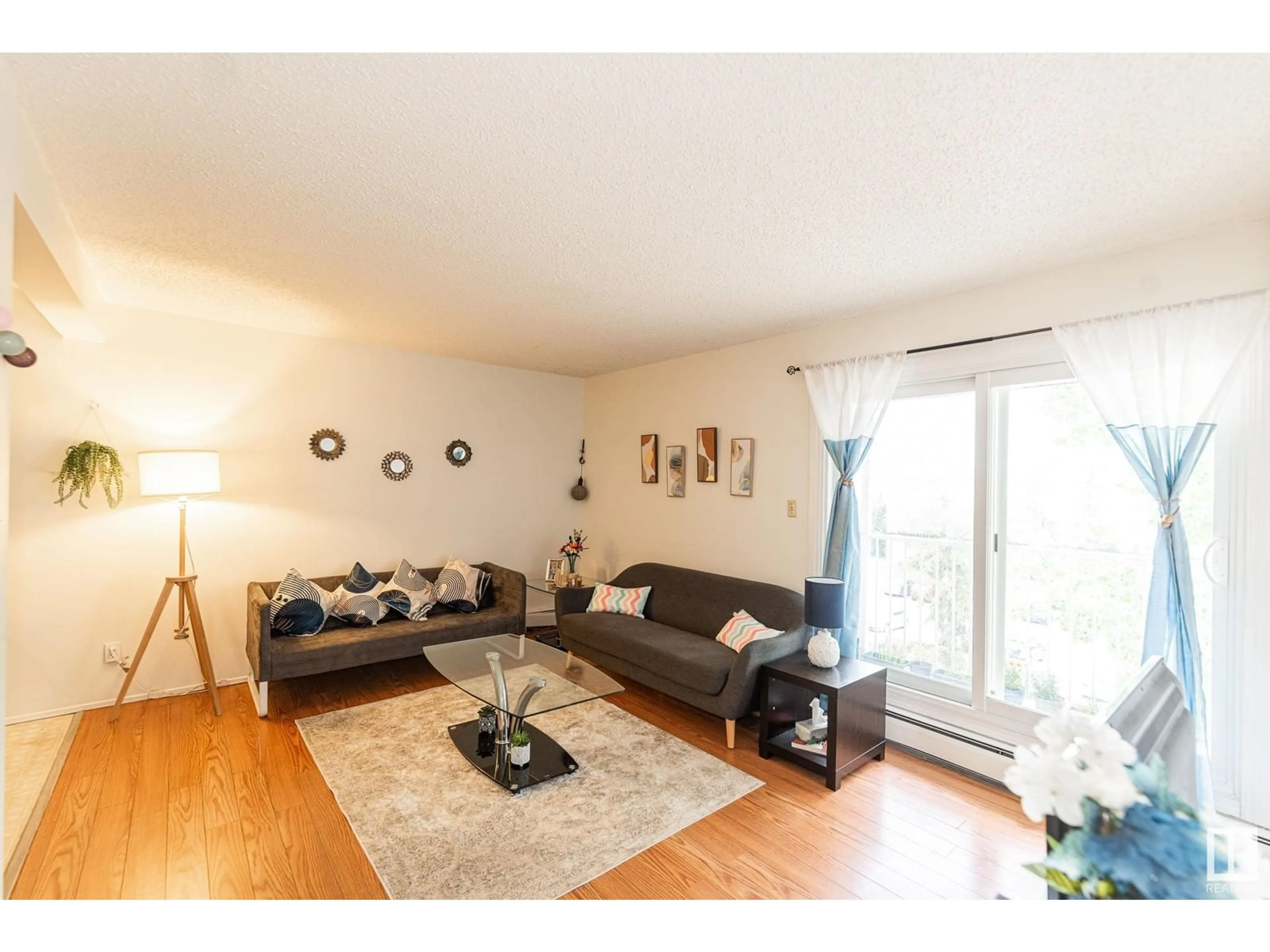 Living room with furniture, wood/laminate floor for 77 - 11265 31 AV, Edmonton Alberta T6J3V7