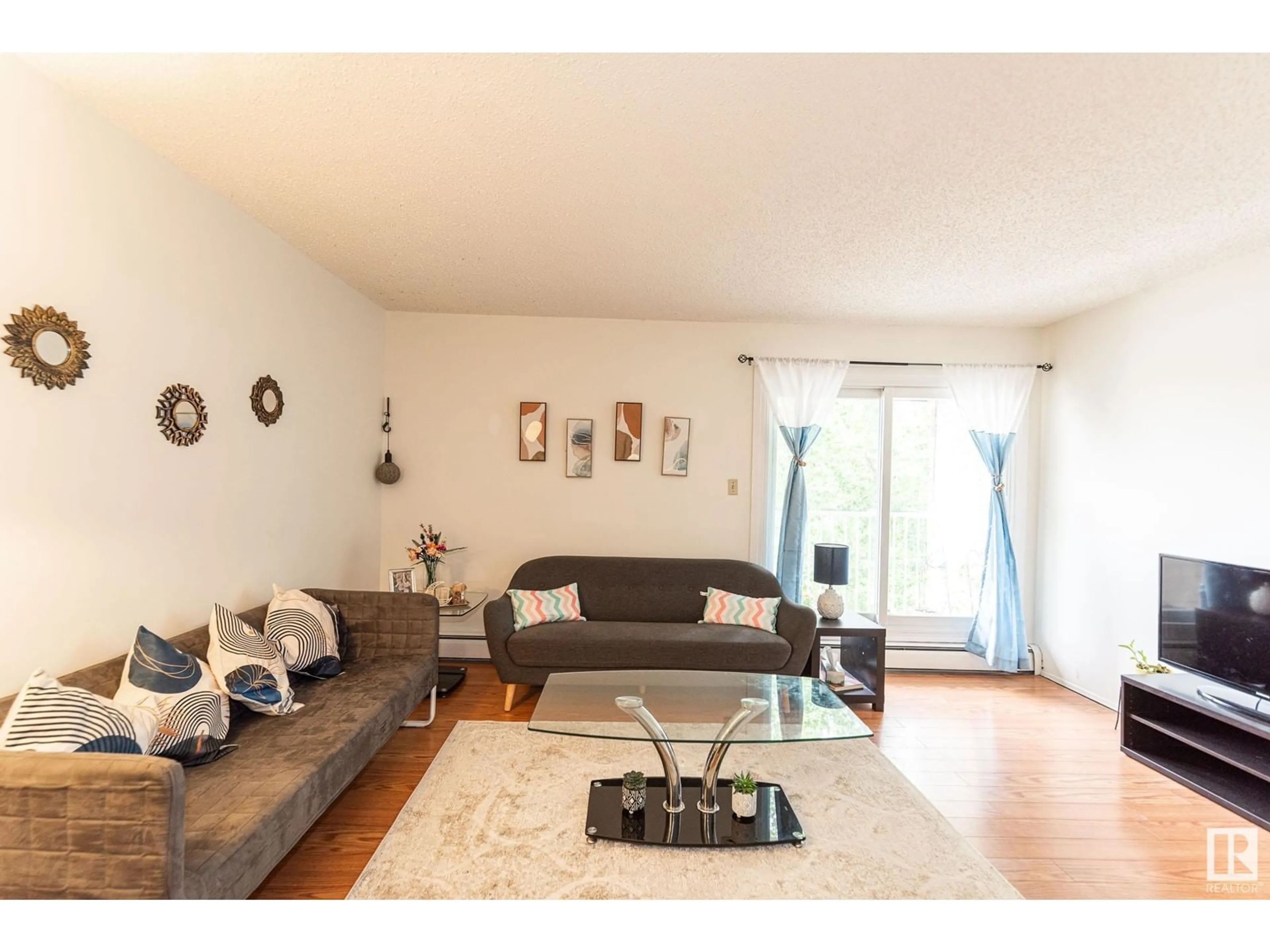 Living room with furniture, wood/laminate floor for 77 - 11265 31 AV, Edmonton Alberta T6J3V7
