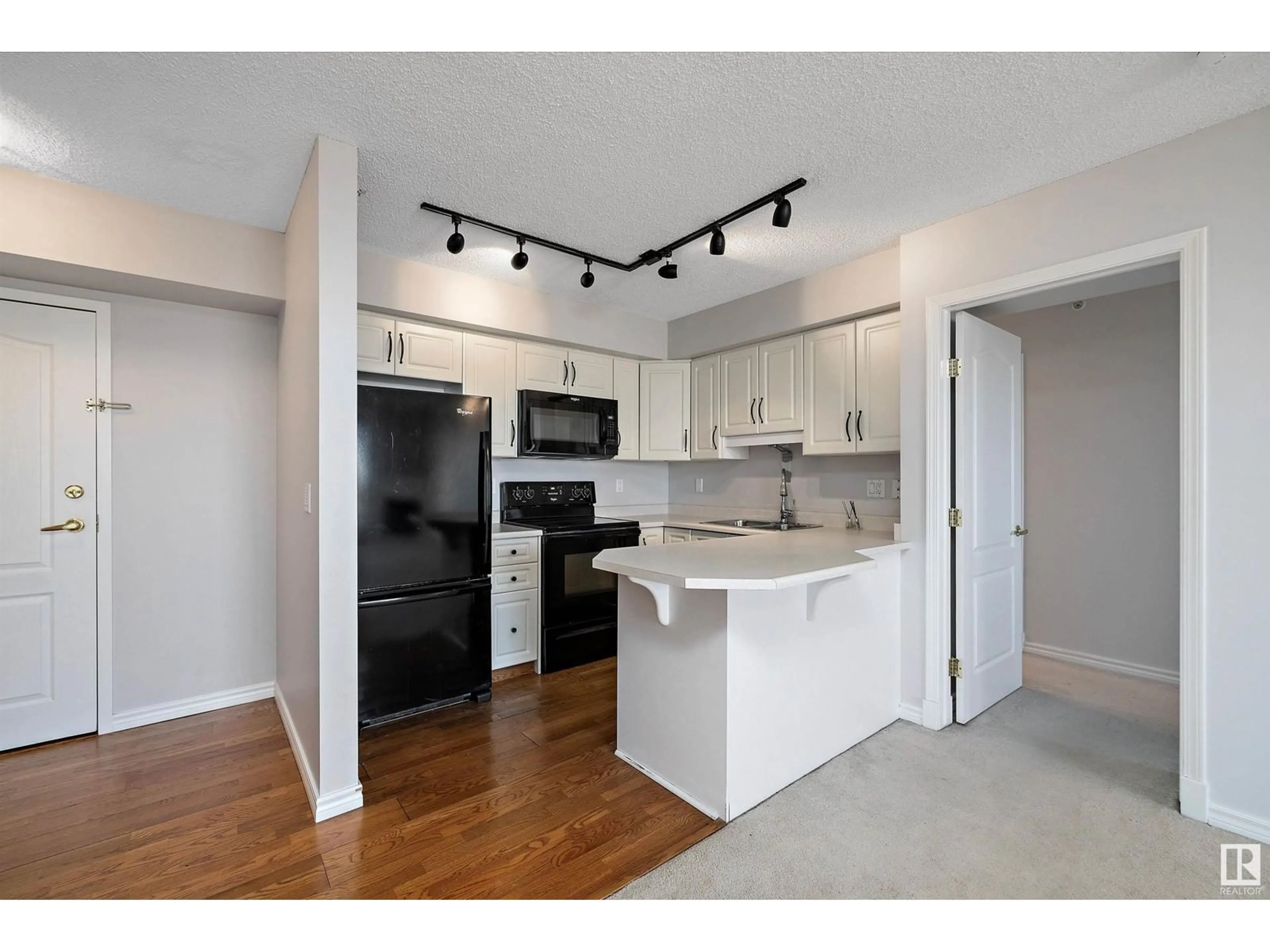 Open concept kitchen, wood/laminate floor for #803 - 10649 SASKATCHEWAN DR, Edmonton Alberta T6E6S8