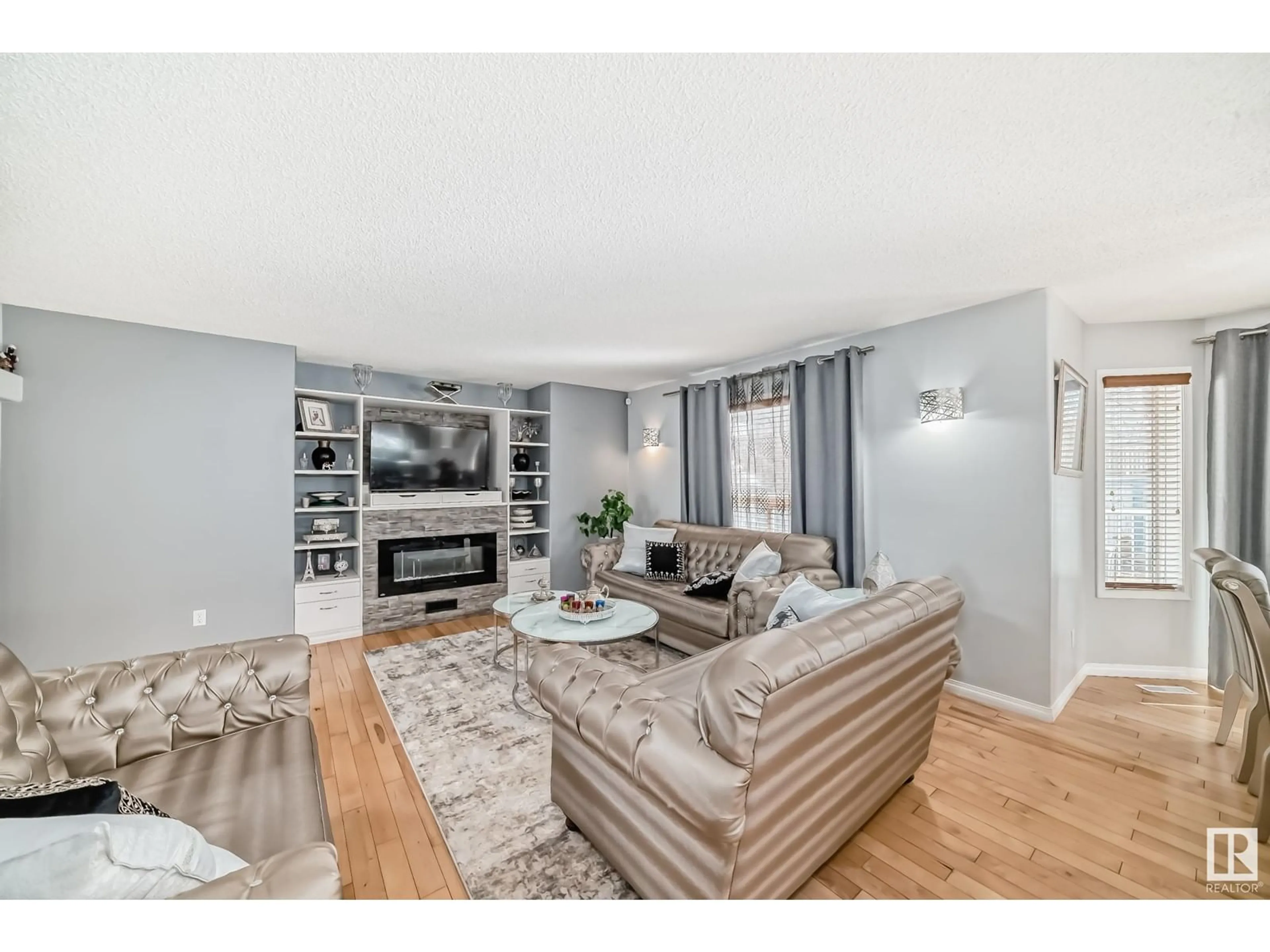 Living room with furniture, wood/laminate floor for NW - 4015 28A ST, Edmonton Alberta T6T1L8