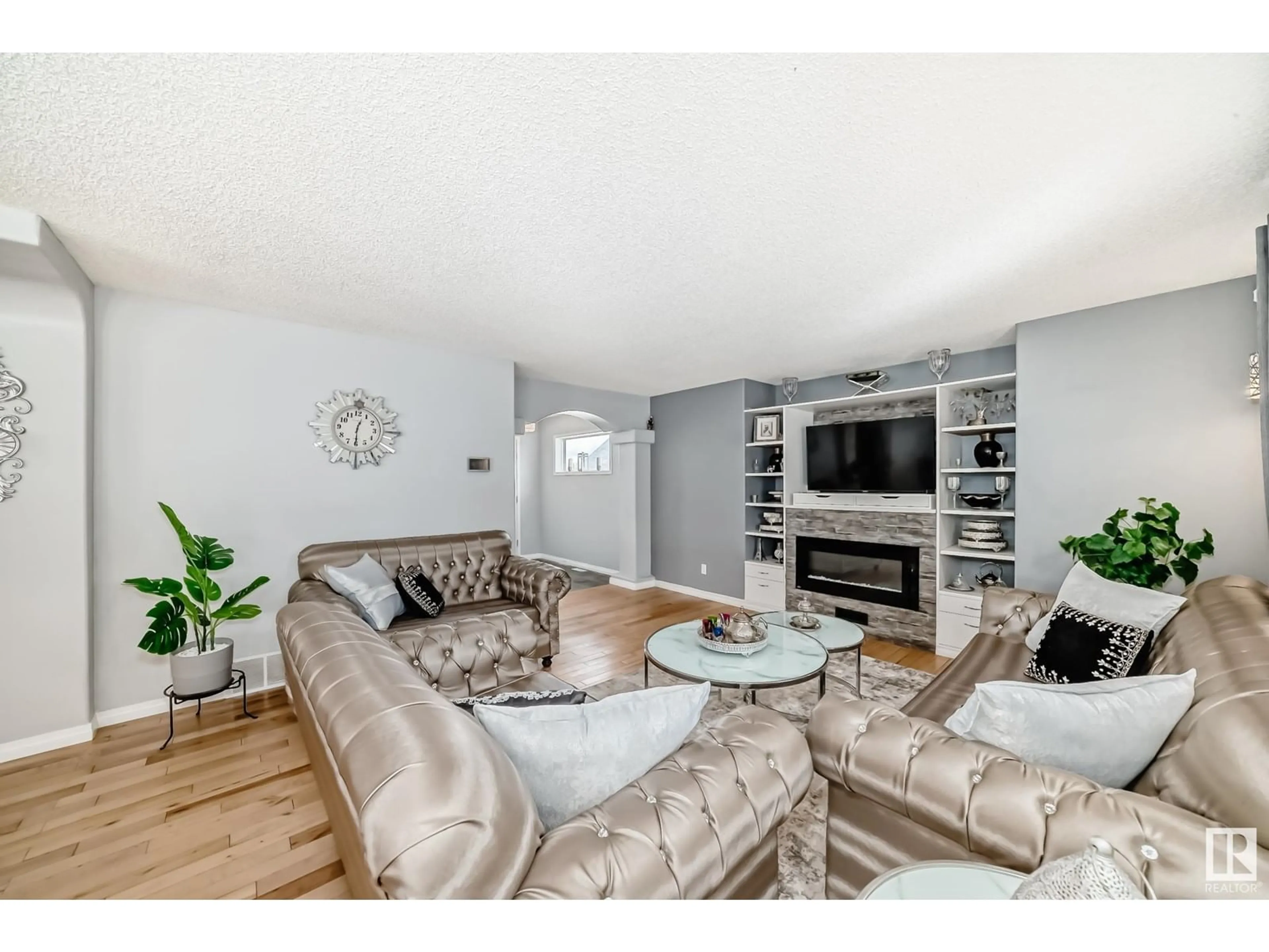 Living room with furniture, wood/laminate floor for NW - 4015 28A ST, Edmonton Alberta T6T1L8