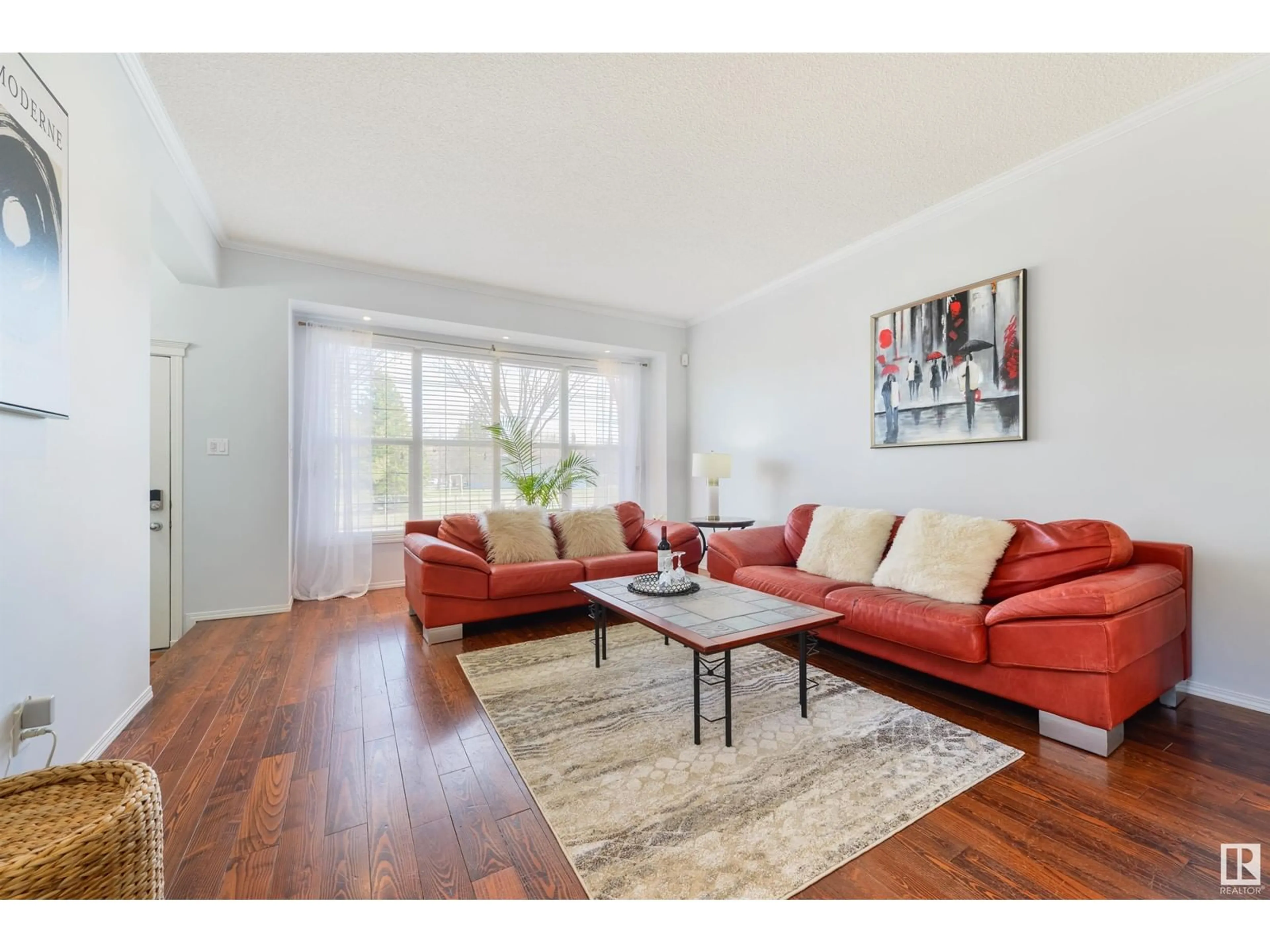 Living room with furniture, wood/laminate floor for NW - 10072 90 ST, Edmonton Alberta T5H4P2