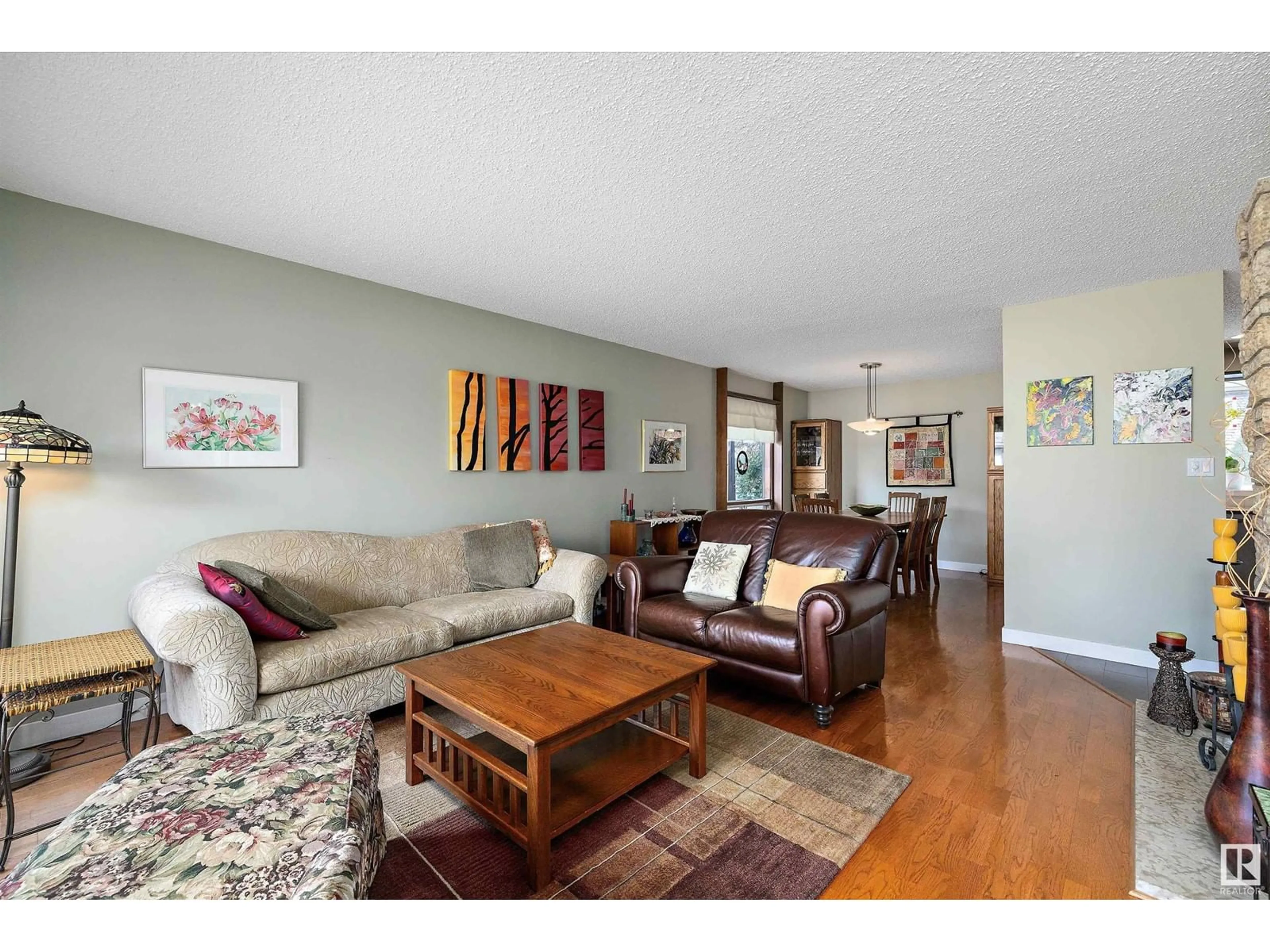 Living room with furniture, wood/laminate floor for NW - 11520 24 AV, Edmonton Alberta T6J3R7