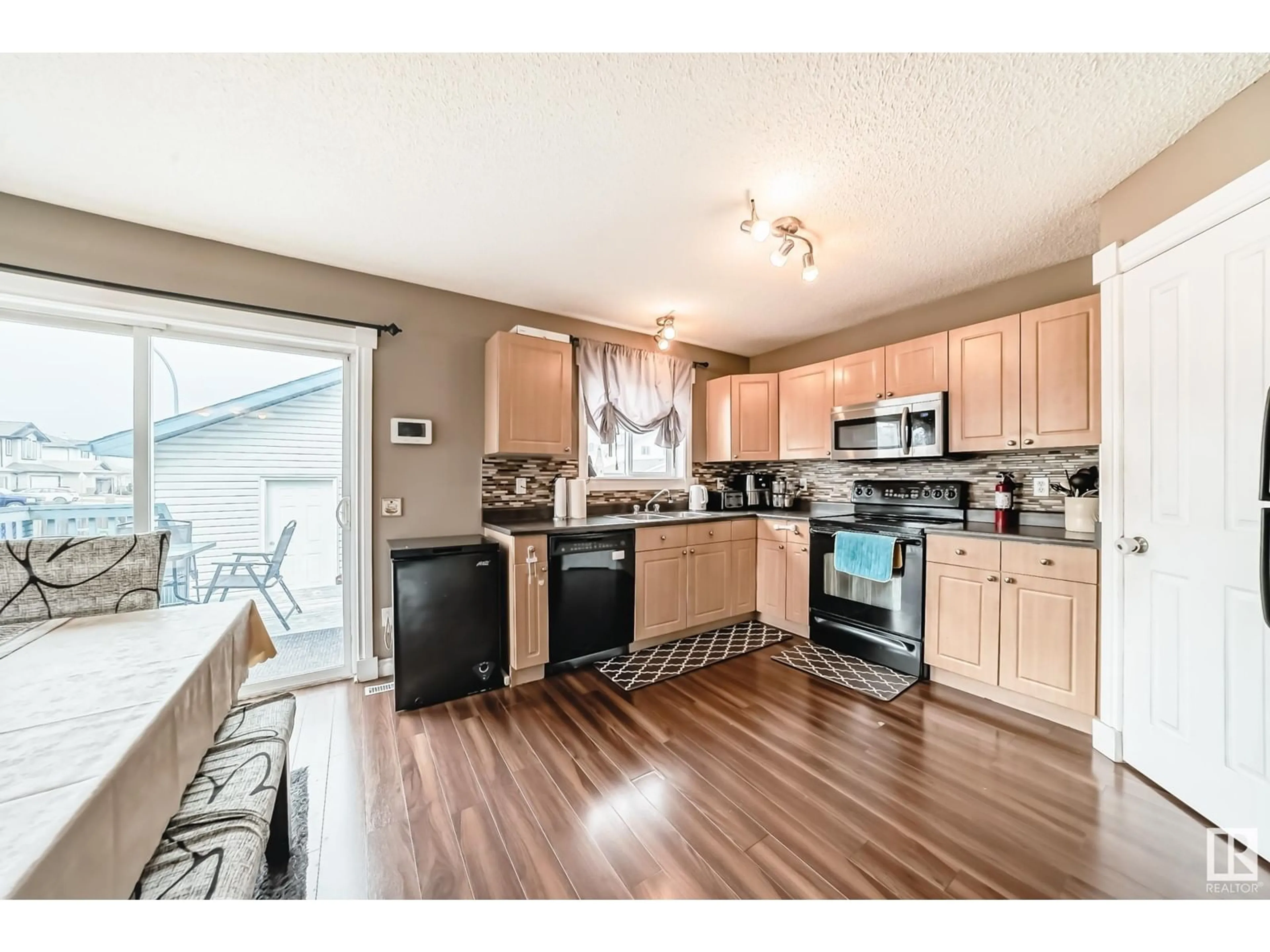Open concept kitchen, wood/laminate floor for 14026 158A AV, Edmonton Alberta T6V1V7