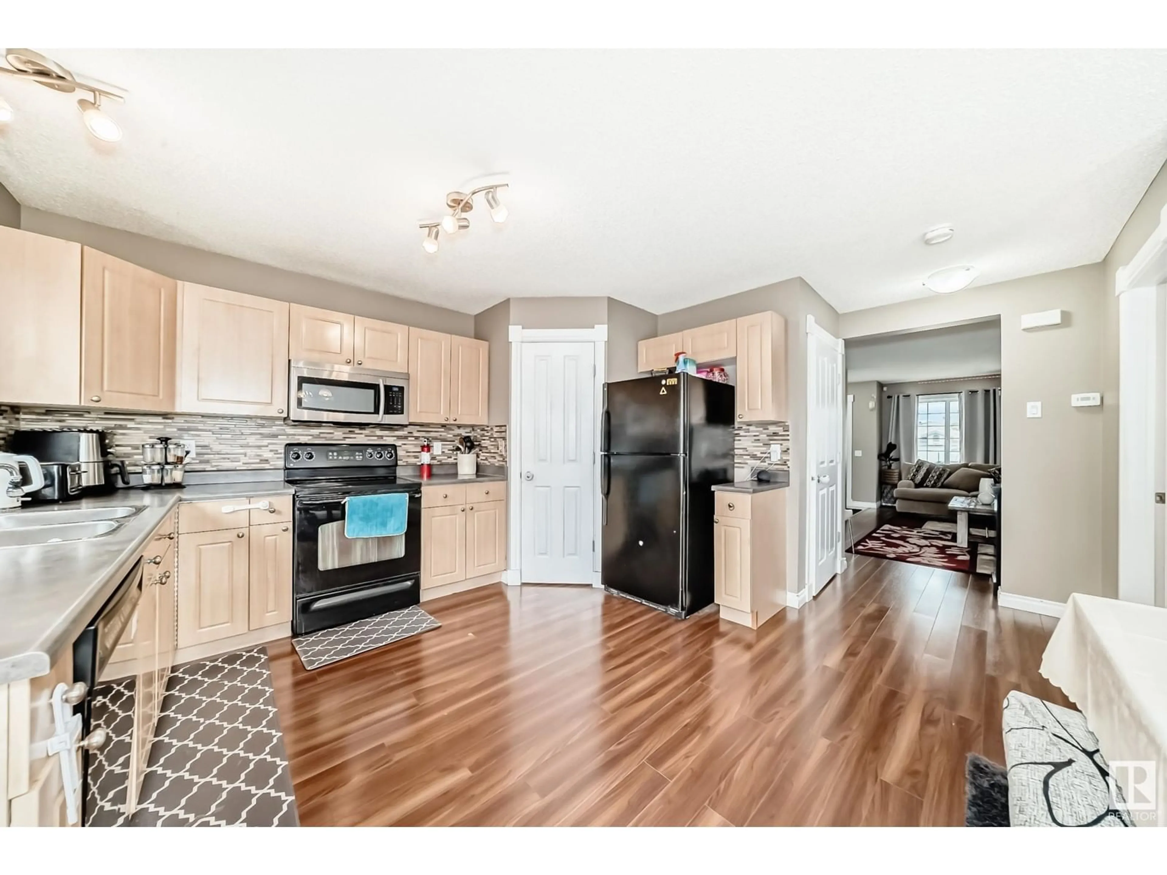 Open concept kitchen, wood/laminate floor for 14026 158A AV, Edmonton Alberta T6V1V7
