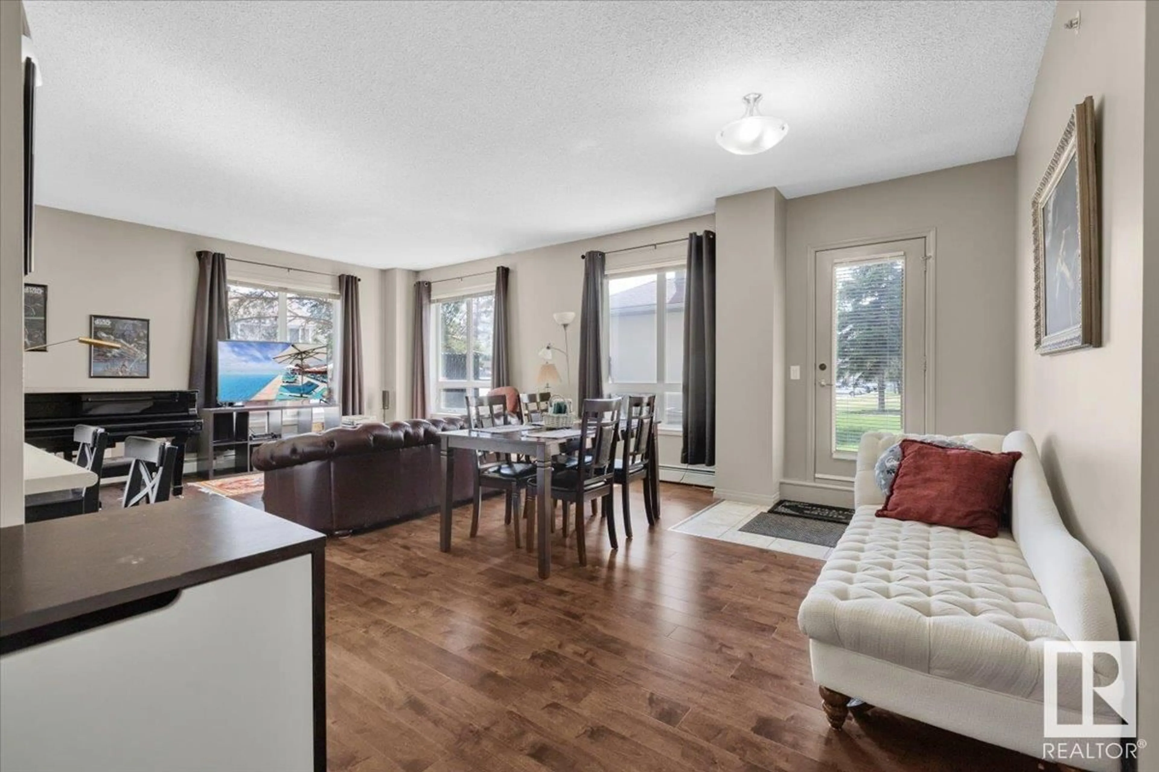 Living room with furniture, wood/laminate floor for #110 - 6315 135 AV, Edmonton Alberta T5A5J7