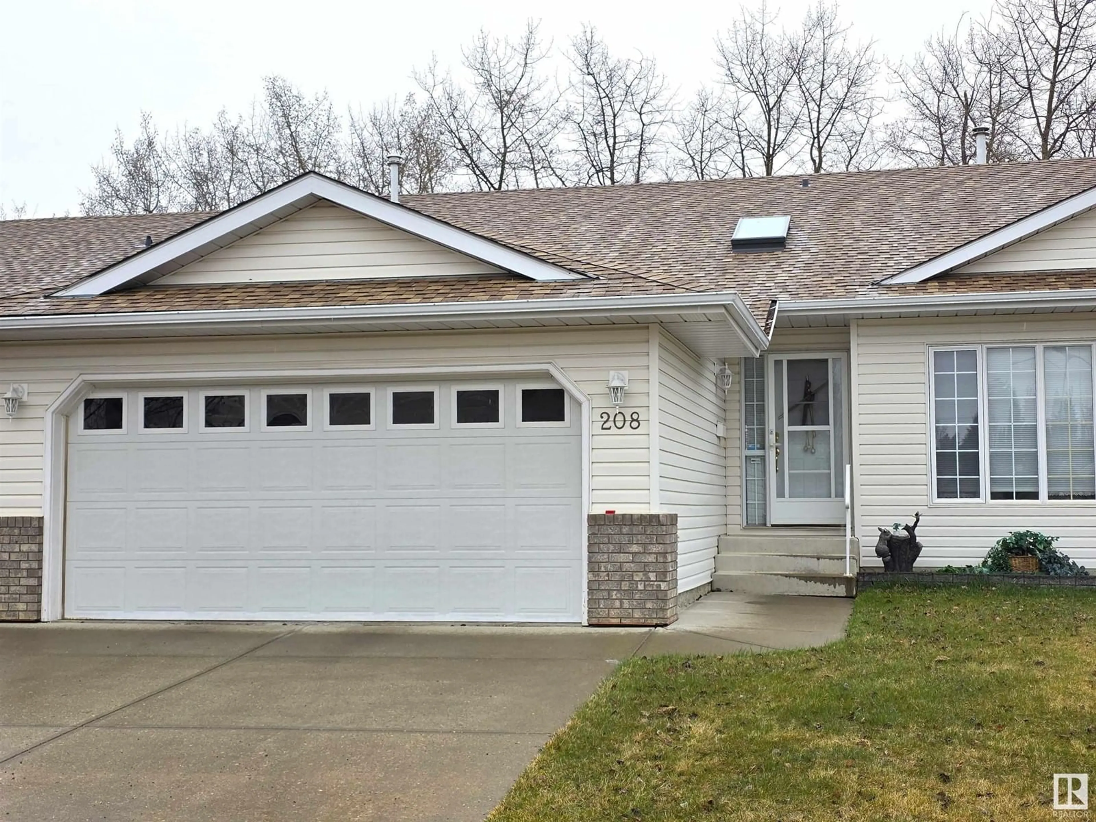 Home with vinyl exterior material, street for 208 RAVINE VI, Leduc Alberta T9E8B9