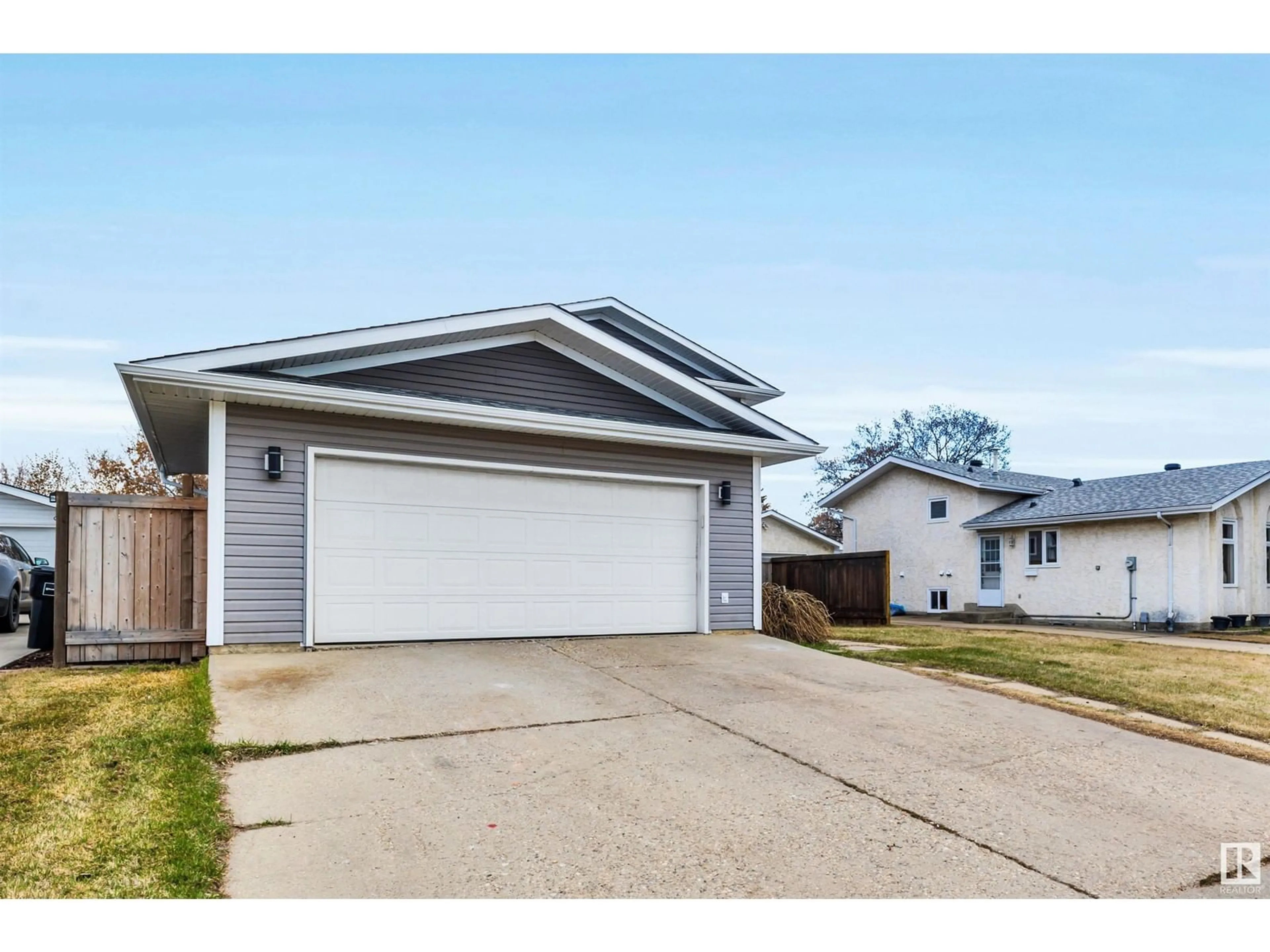 Home with vinyl exterior material, street for 14225 24A ST NW, Edmonton Alberta T5Y1N7