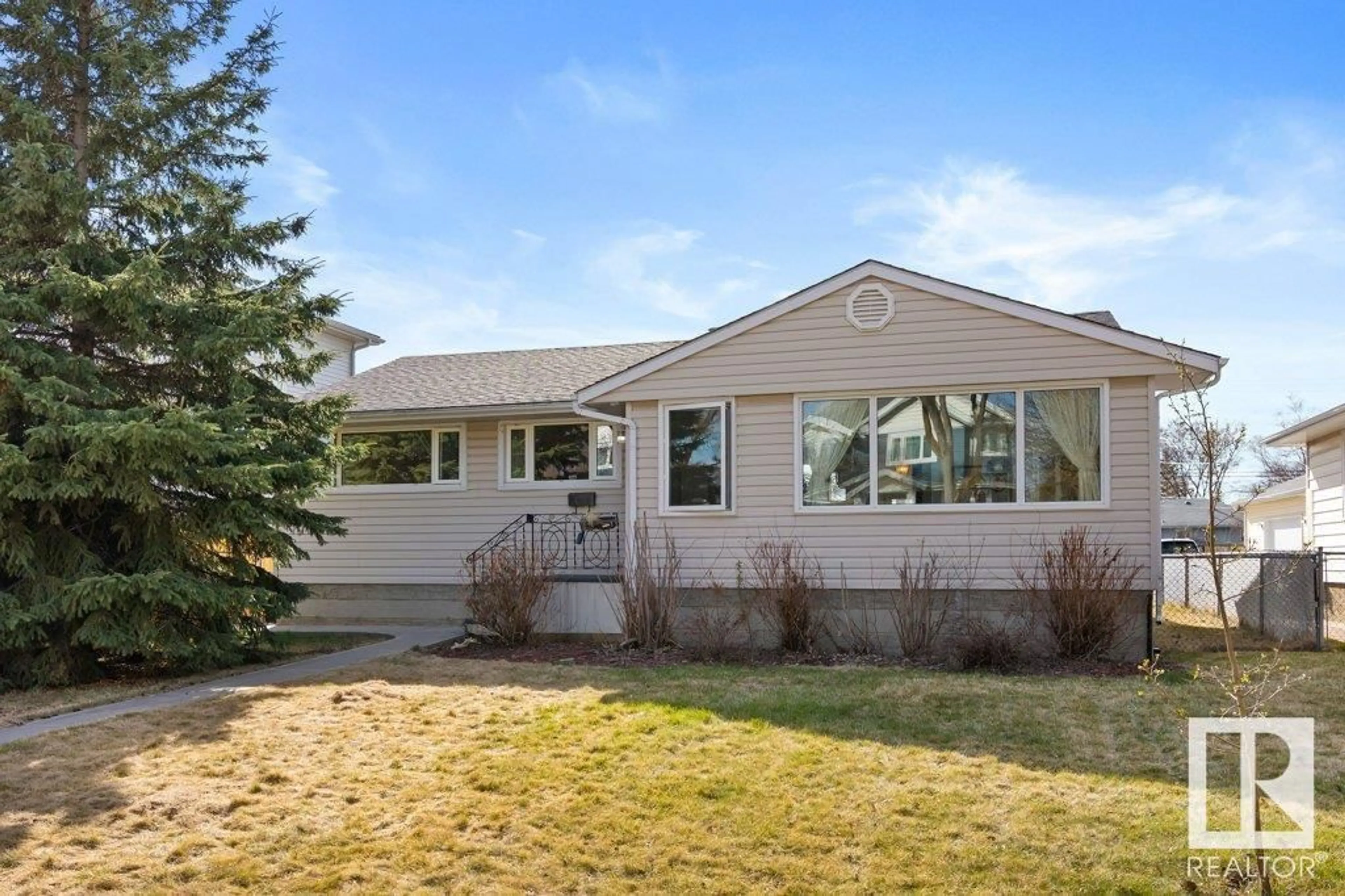 Home with vinyl exterior material, street for 9428 77 ST, Edmonton Alberta T6C2M6