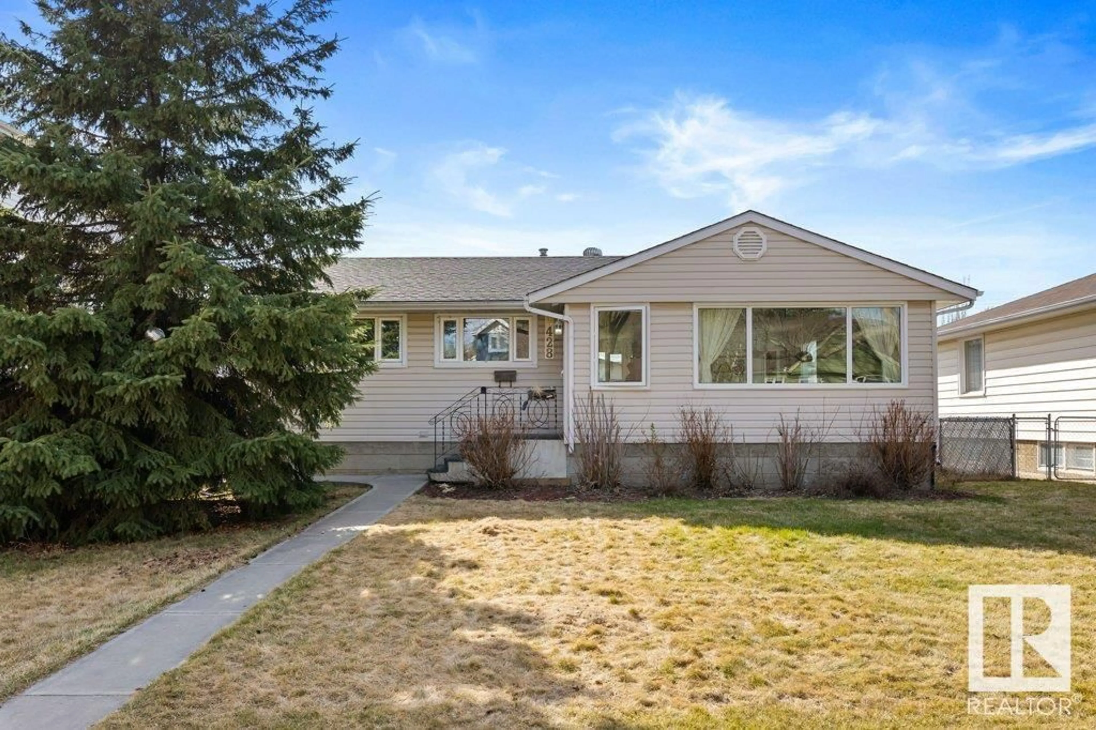 Home with vinyl exterior material, street for 9428 77 ST, Edmonton Alberta T6C2M6