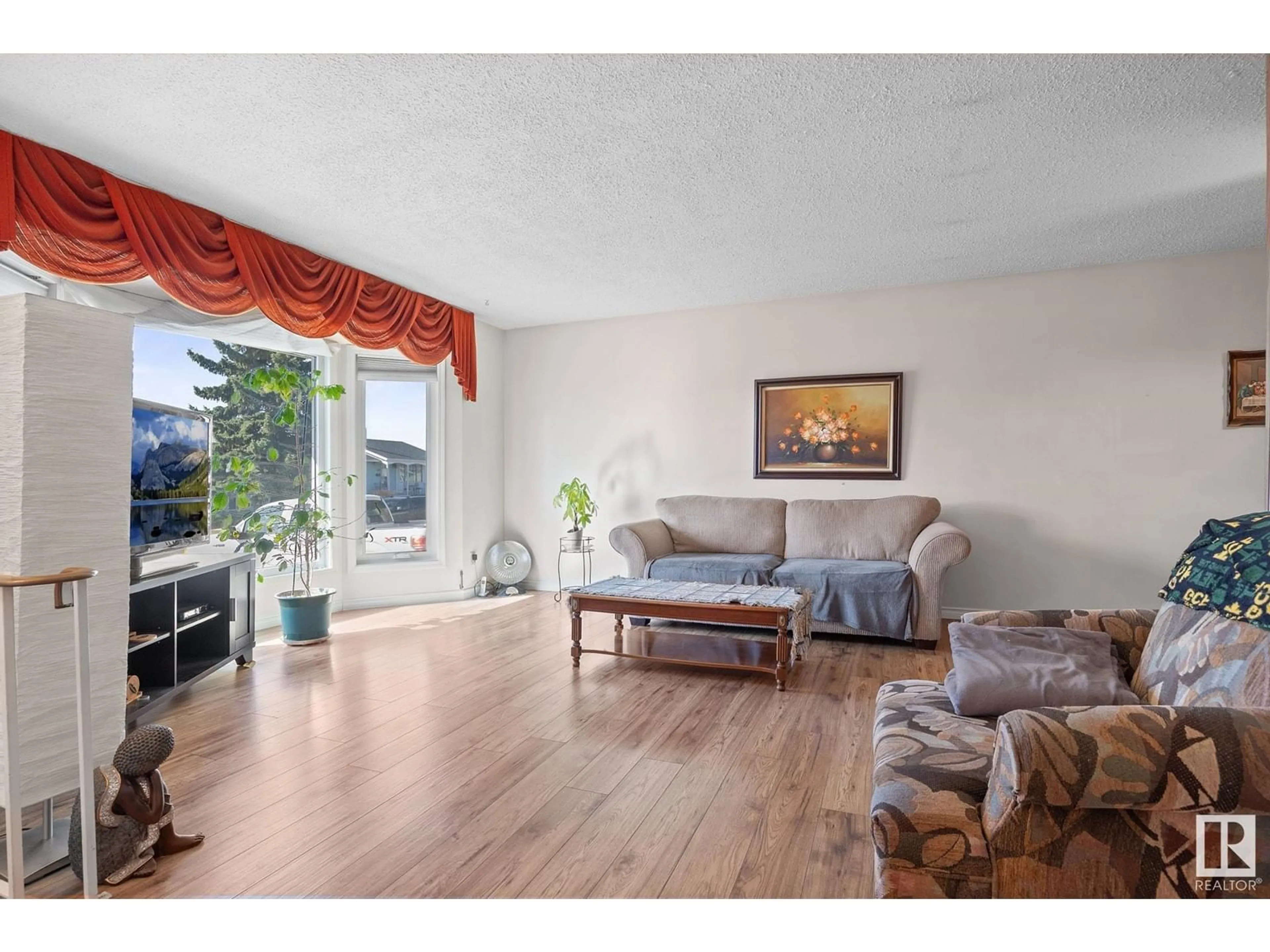 Living room with furniture, wood/laminate floor for 4112 136 AV, Edmonton Alberta T5A2W8