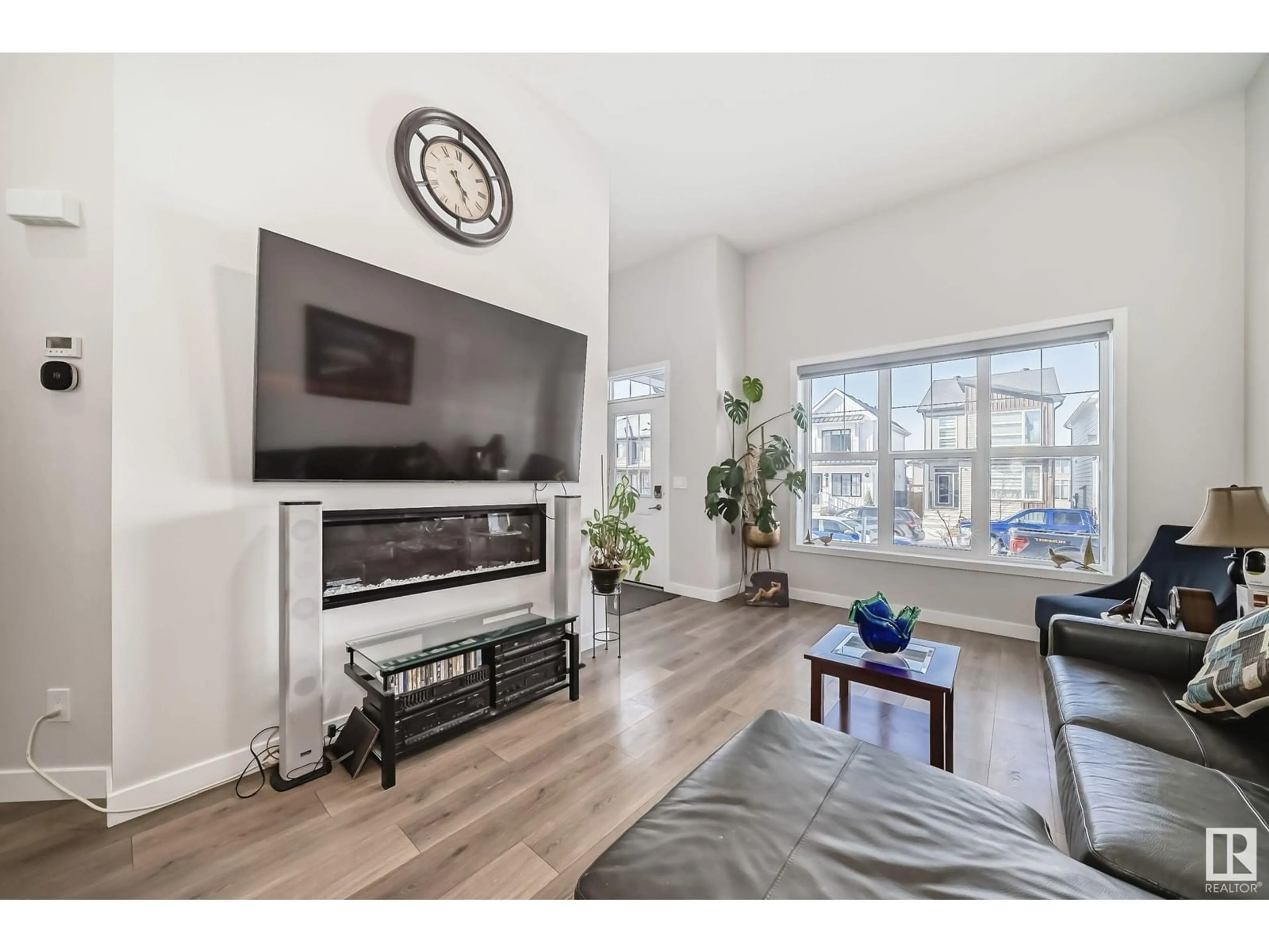 Living room with furniture, wood/laminate floor for LI SW - 5029 KINNEY LINK, Edmonton Alberta T6W5G5