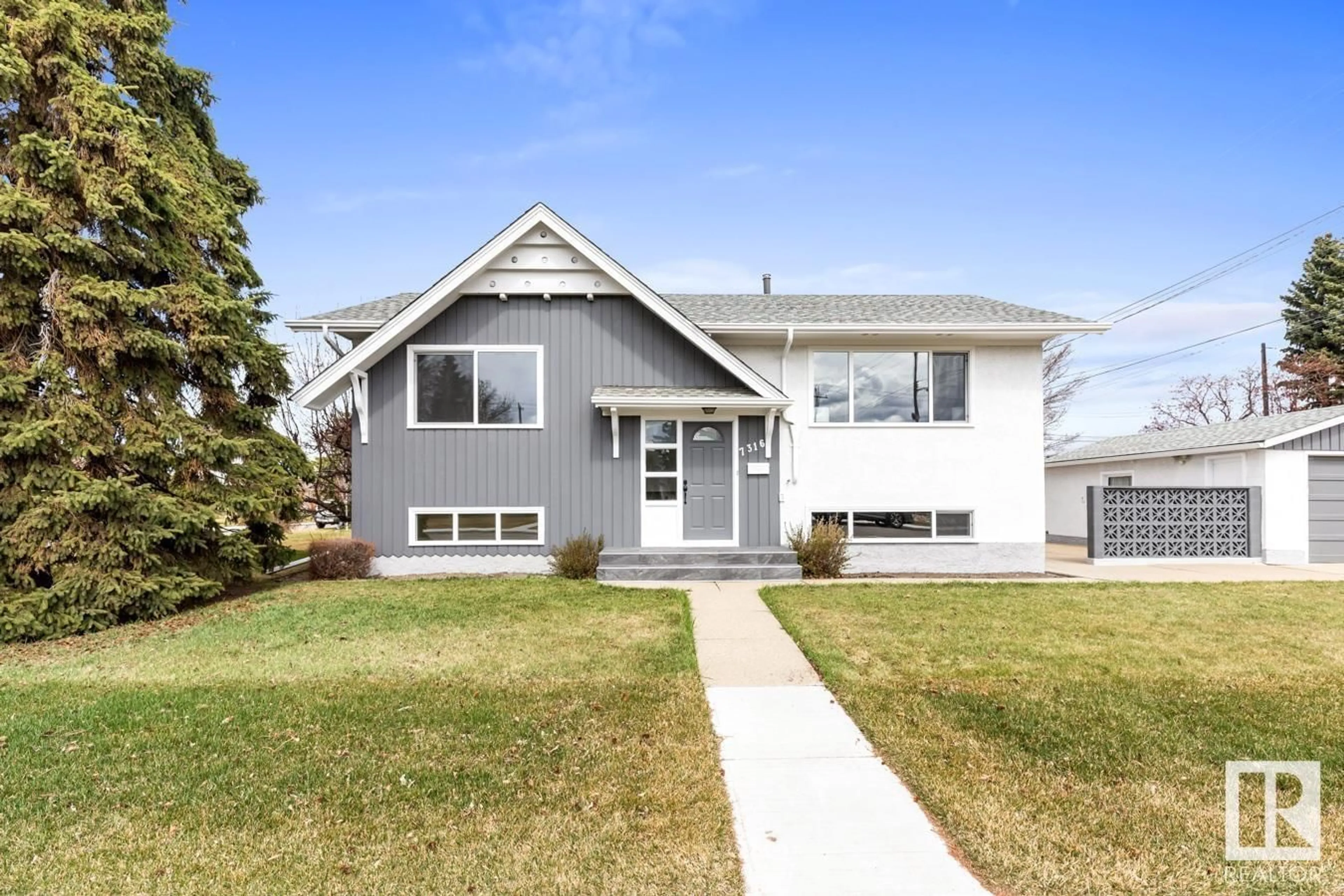 Home with vinyl exterior material, street for 7316 95 AV, Edmonton Alberta T6B1B2