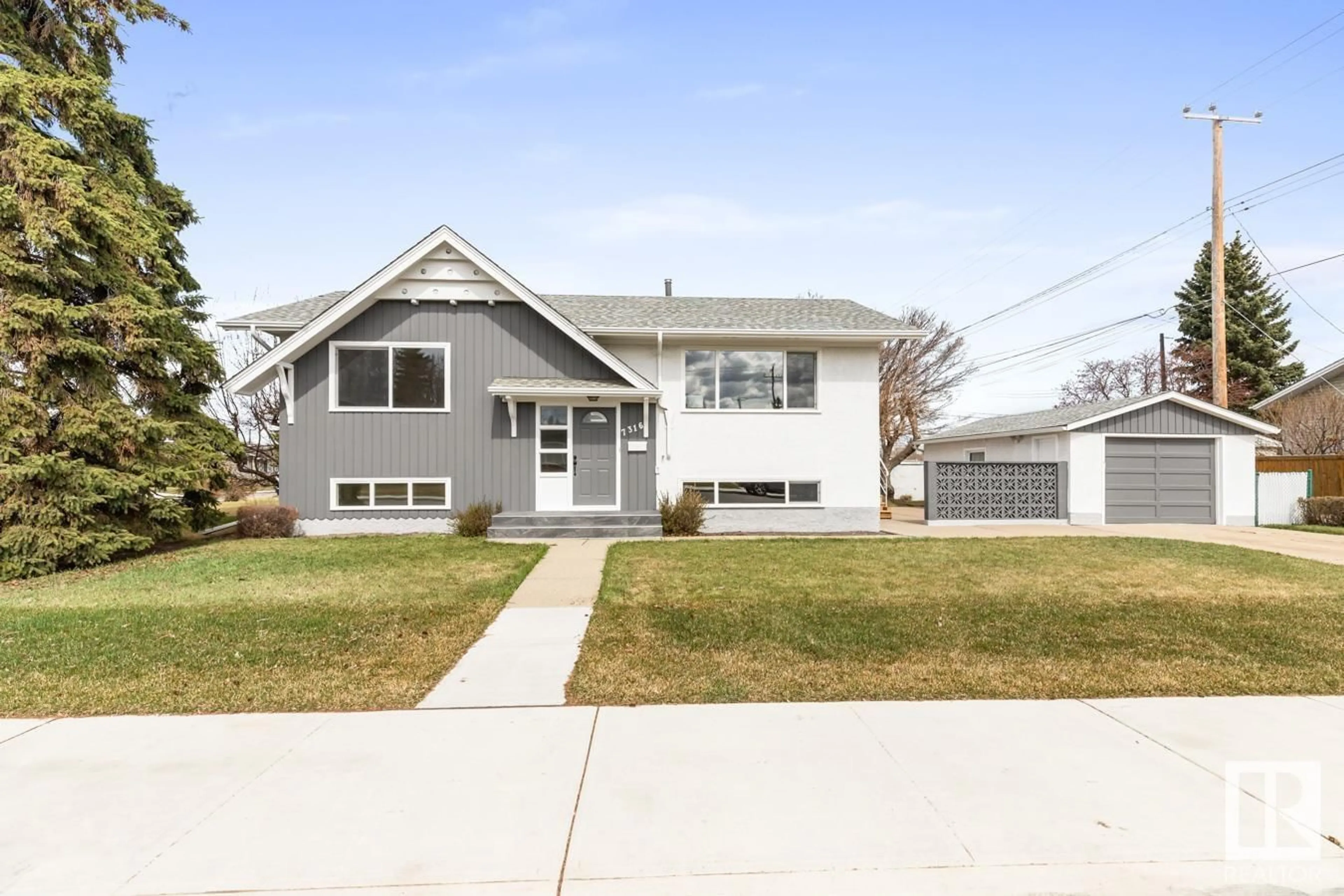 Home with vinyl exterior material, street for 7316 95 AV, Edmonton Alberta T6B1B2