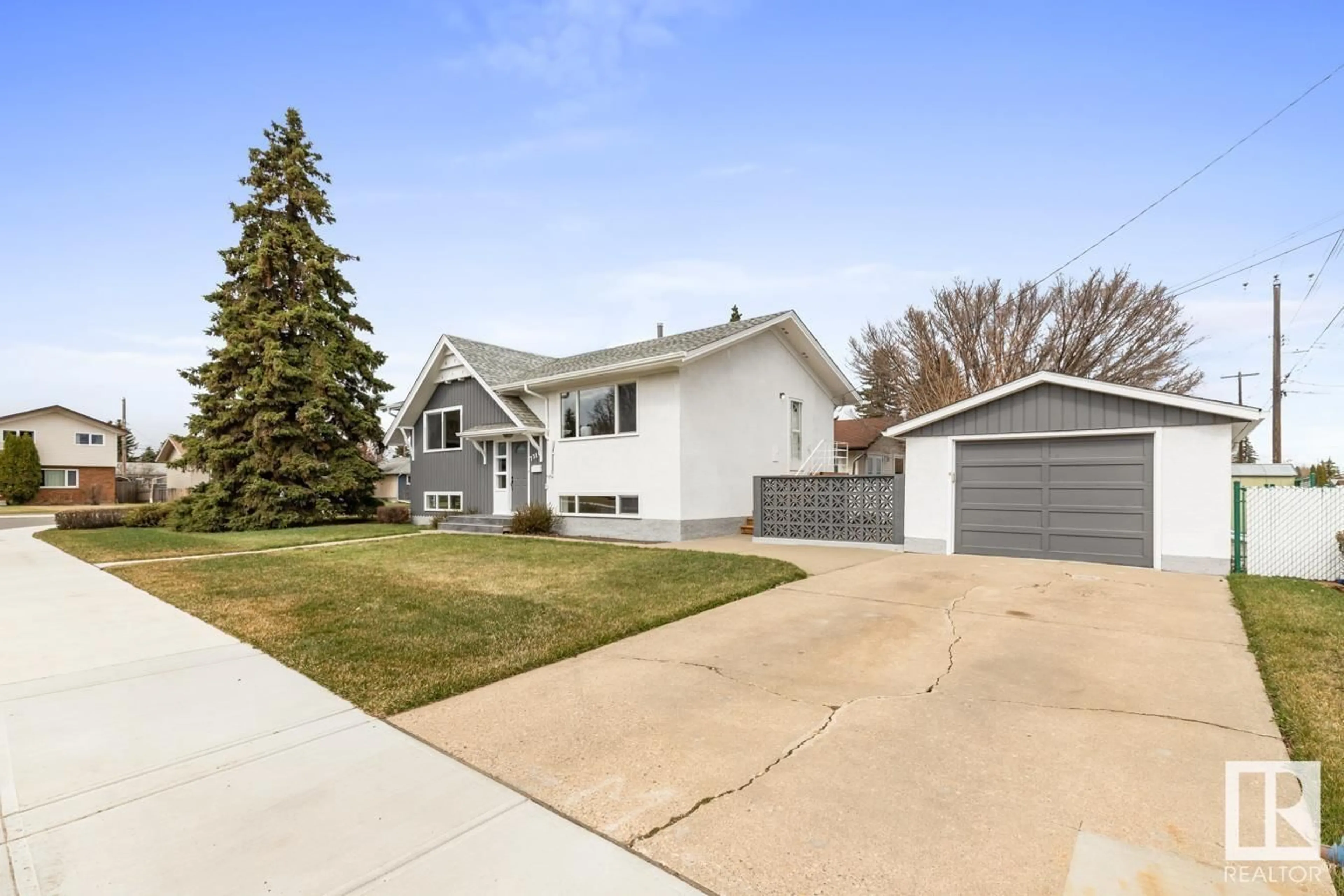 Home with vinyl exterior material, street for 7316 95 AV, Edmonton Alberta T6B1B2