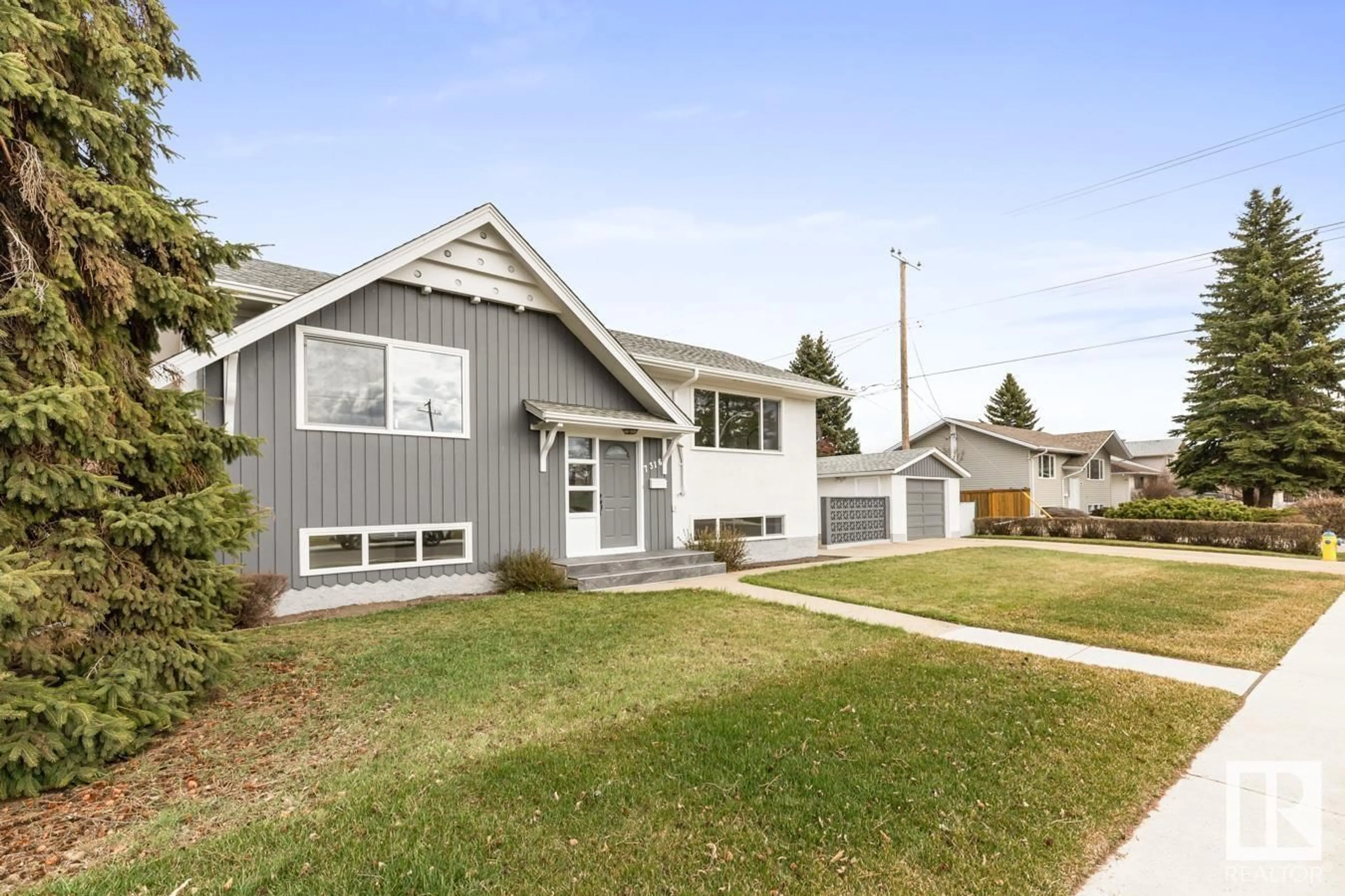 Home with vinyl exterior material, street for 7316 95 AV, Edmonton Alberta T6B1B2