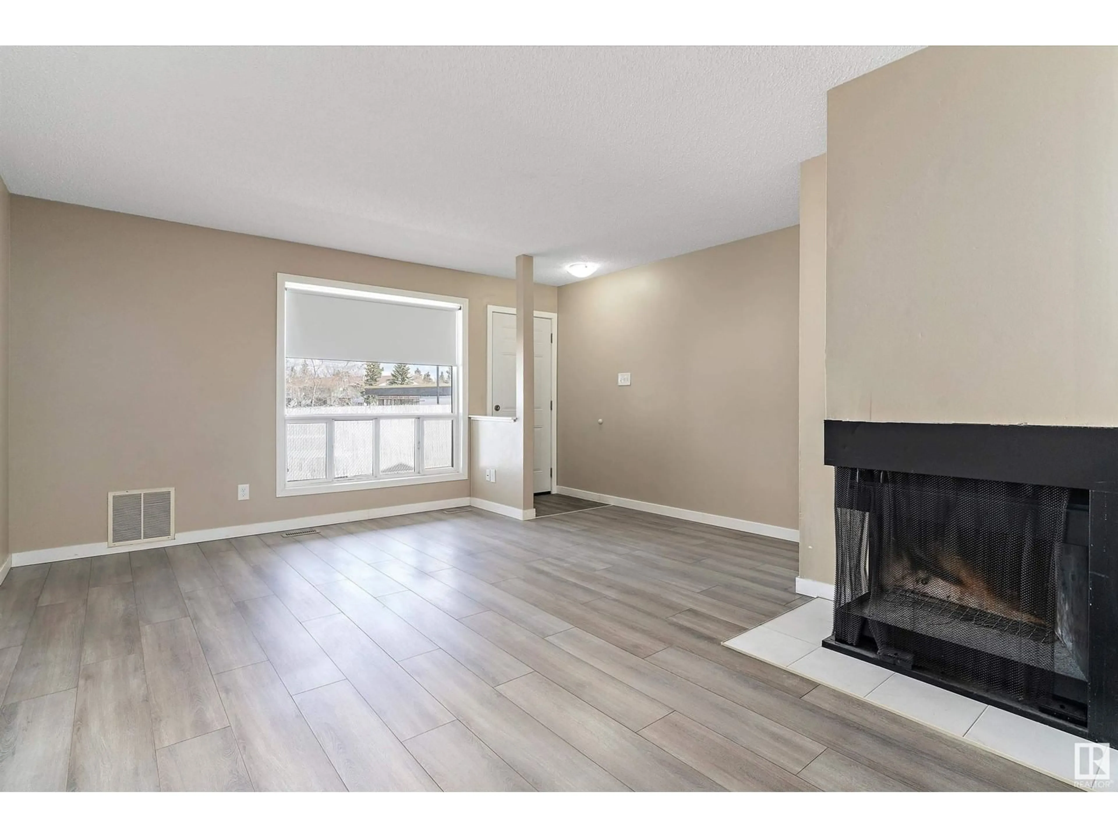 Living room with furniture, wood/laminate floor for 44 - 1503 MILL WOODS E NW, Edmonton Alberta T6L4C2