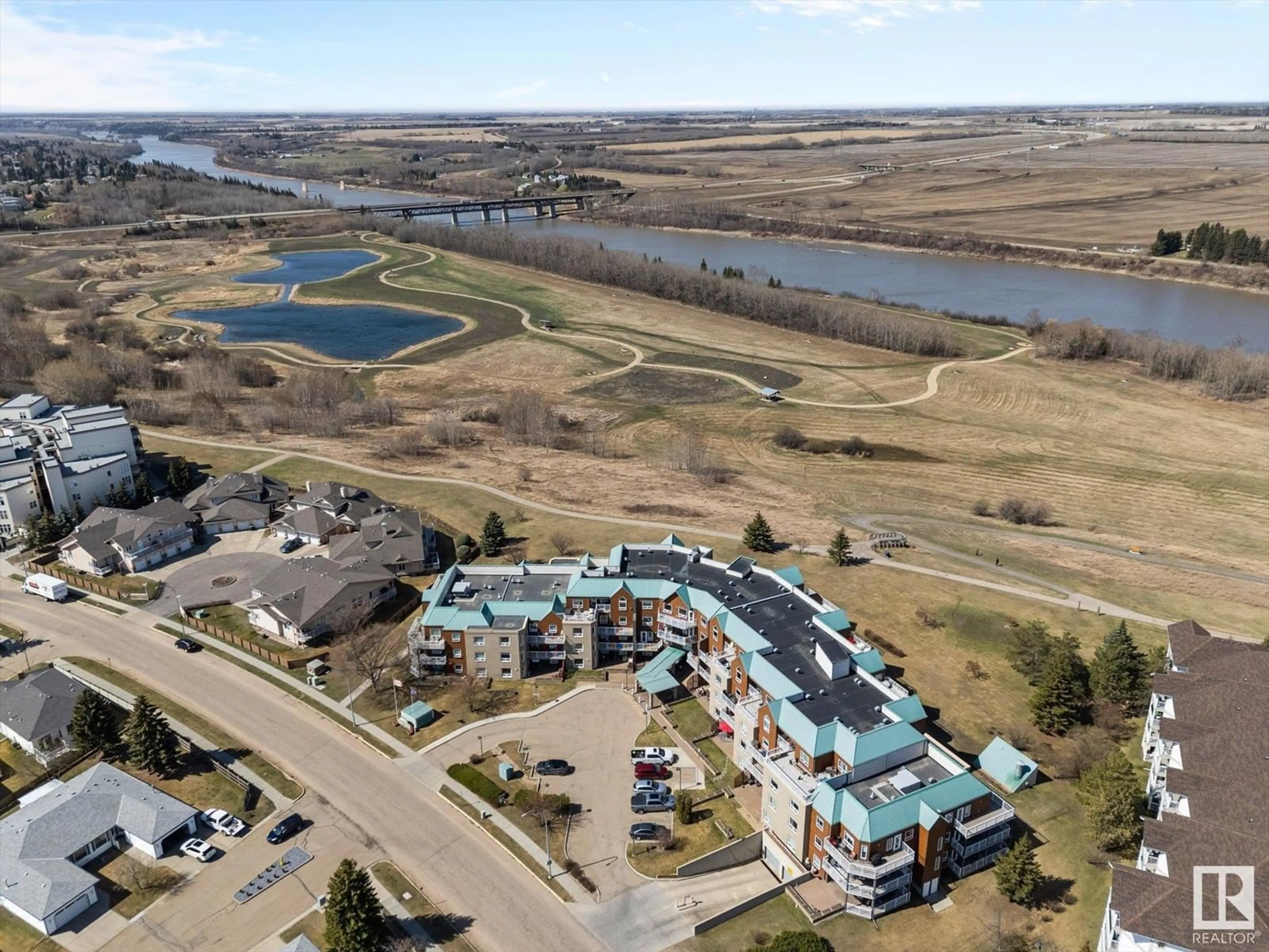 A pic from outside/outdoor area/front of a property/back of a property/a pic from drone, water/lake/river/ocean view for 218 - 9926 100 AV, Fort Saskatchewan Alberta T8L4E3