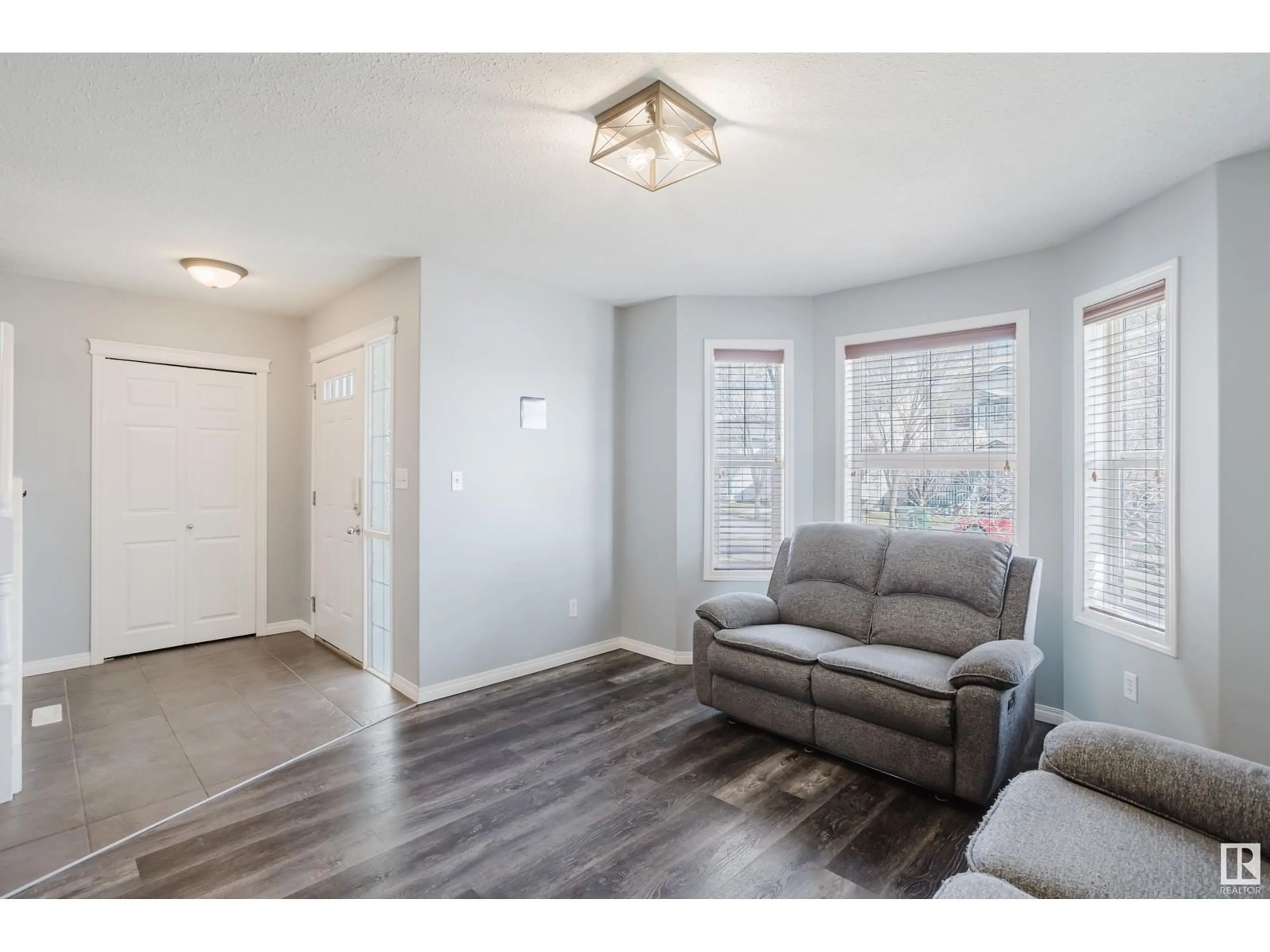Living room with furniture, wood/laminate floor for 3004 49 ST, Beaumont Alberta T4X1S6