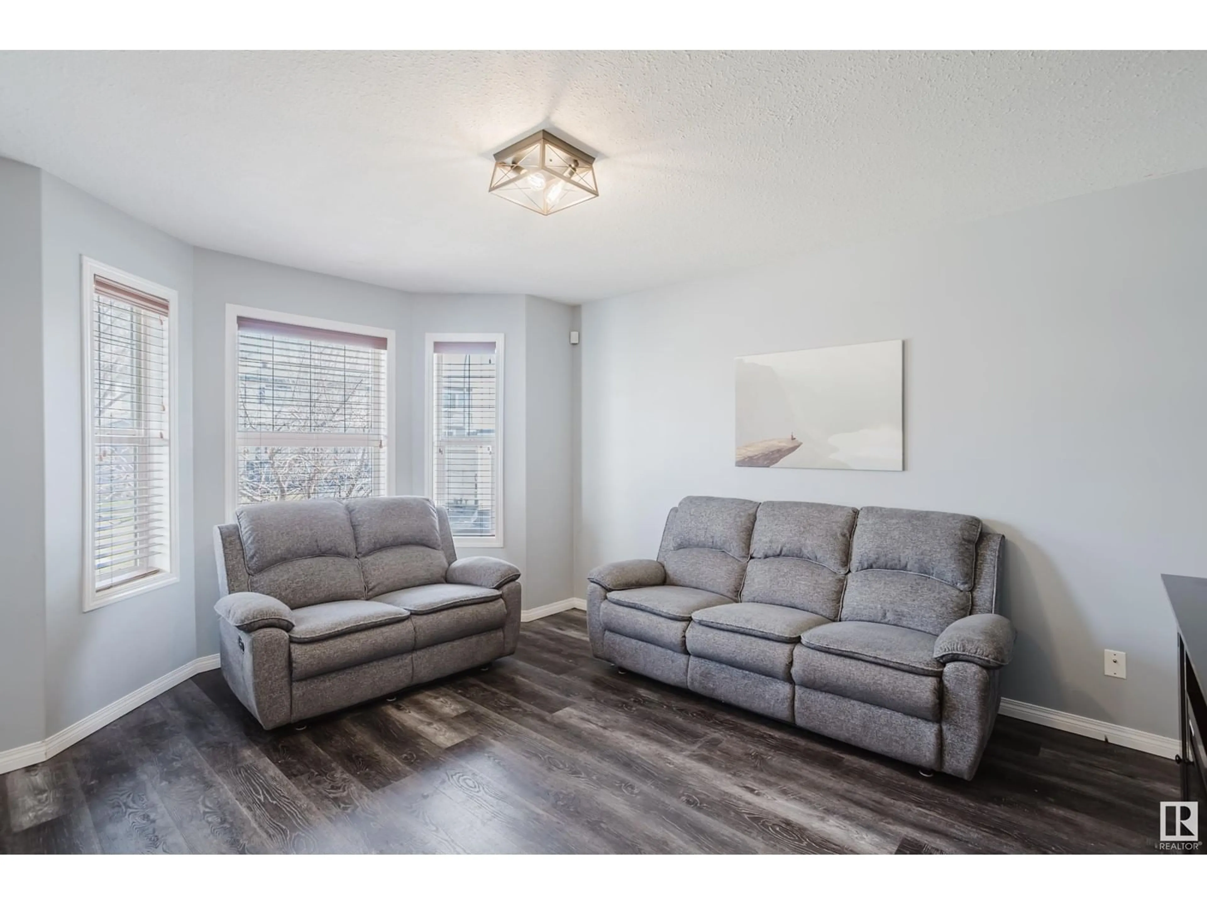 Living room with furniture, wood/laminate floor for 3004 49 ST, Beaumont Alberta T4X1S6