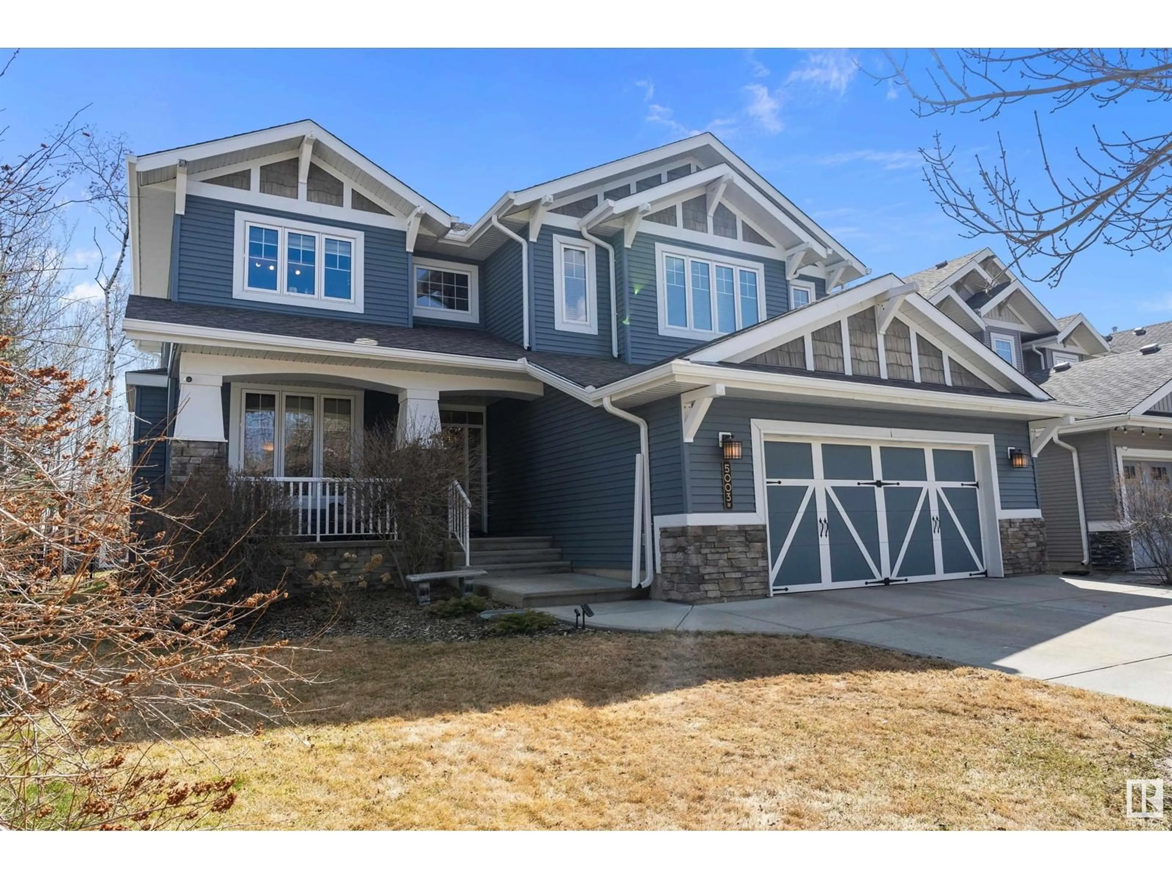Home with vinyl exterior material, street for NW - 5003 210 ST, Edmonton Alberta T6M0A8