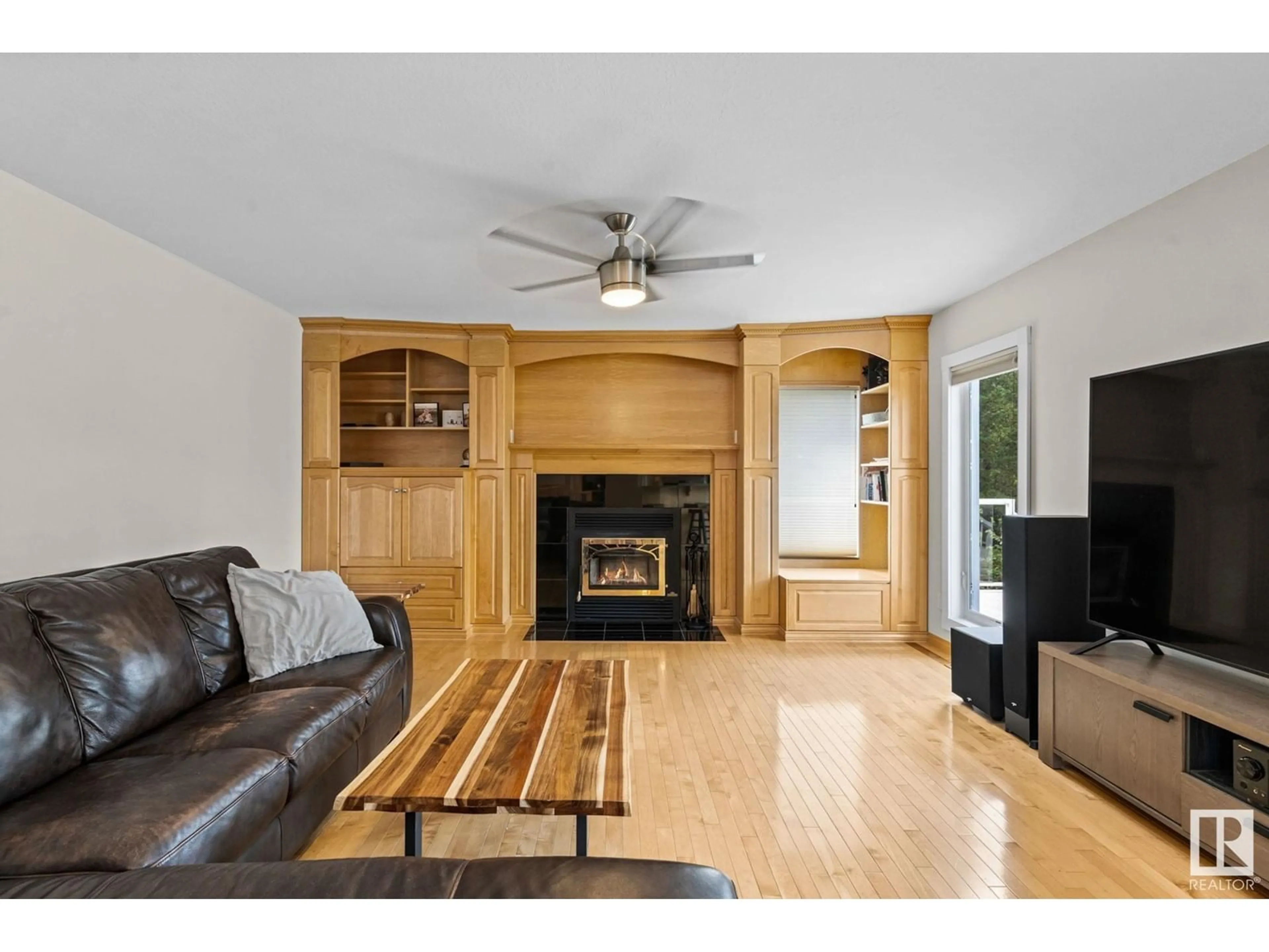 Living room with furniture, wood/laminate floor for 52514 - 277 RGE ROAD 223, Rural Strathcona County Alberta T8A4R5