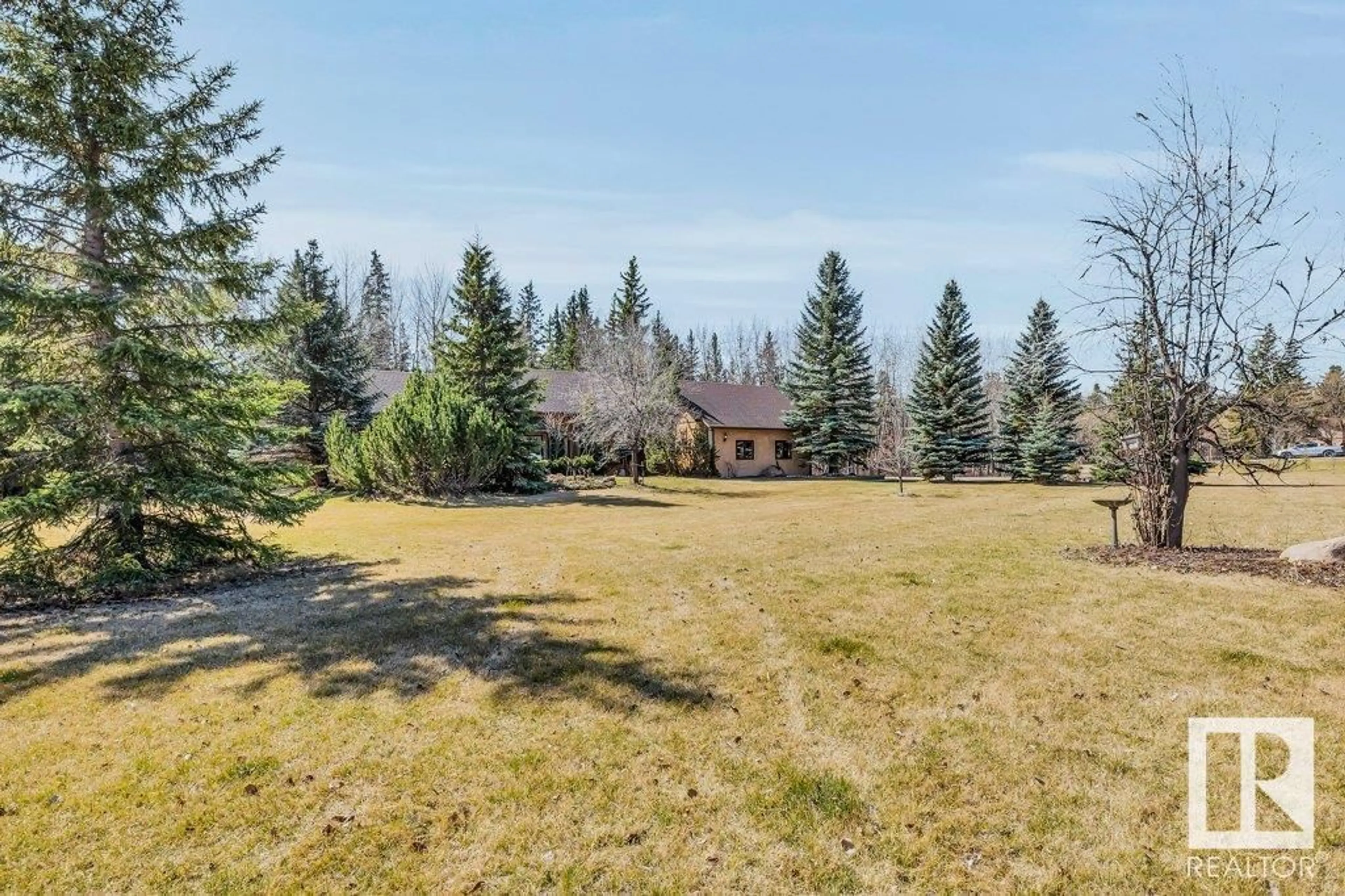 A pic from outside/outdoor area/front of a property/back of a property/a pic from drone, forest/trees view for 7 - 26123 TWP RD 511, Rural Parkland County Alberta T7Y1B9