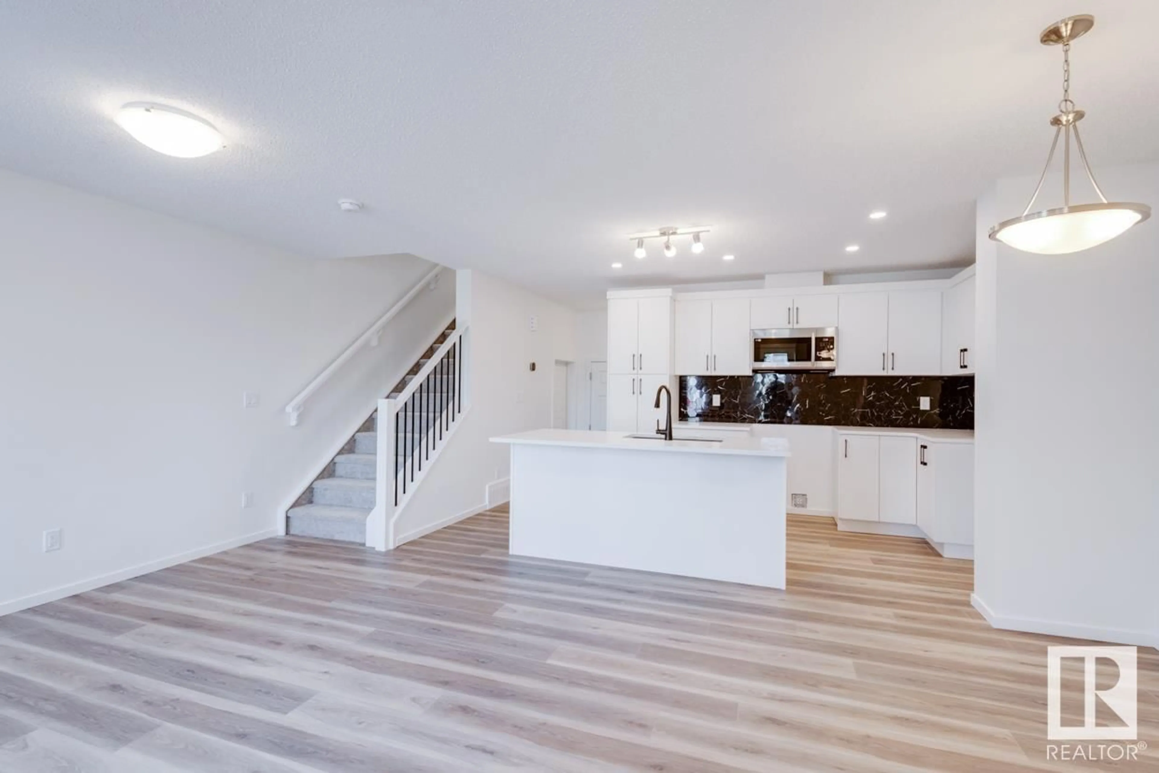 Open concept kitchen, wood/laminate floor for 1046 HEARTHSTONE BV, Sherwood Park Alberta T6H5E5