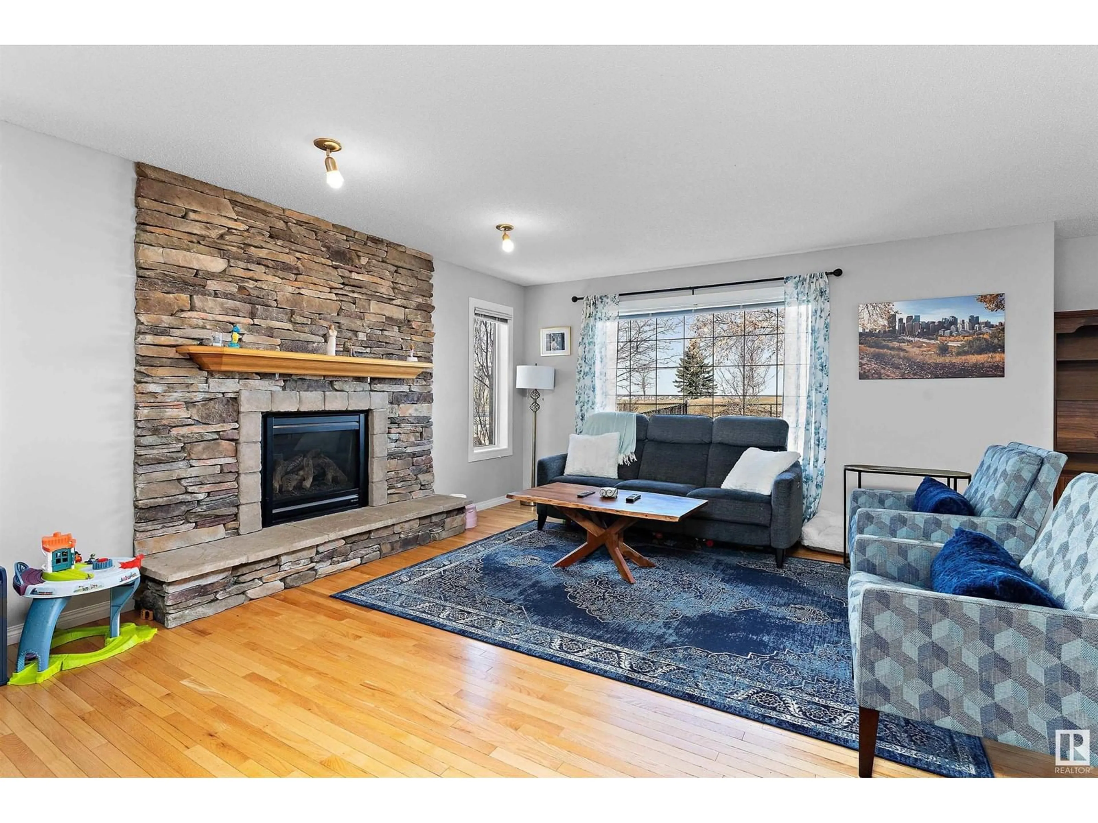 Living room with furniture, wood/laminate floor for 106 RIDEAU CR, Beaumont Alberta T4X0B9