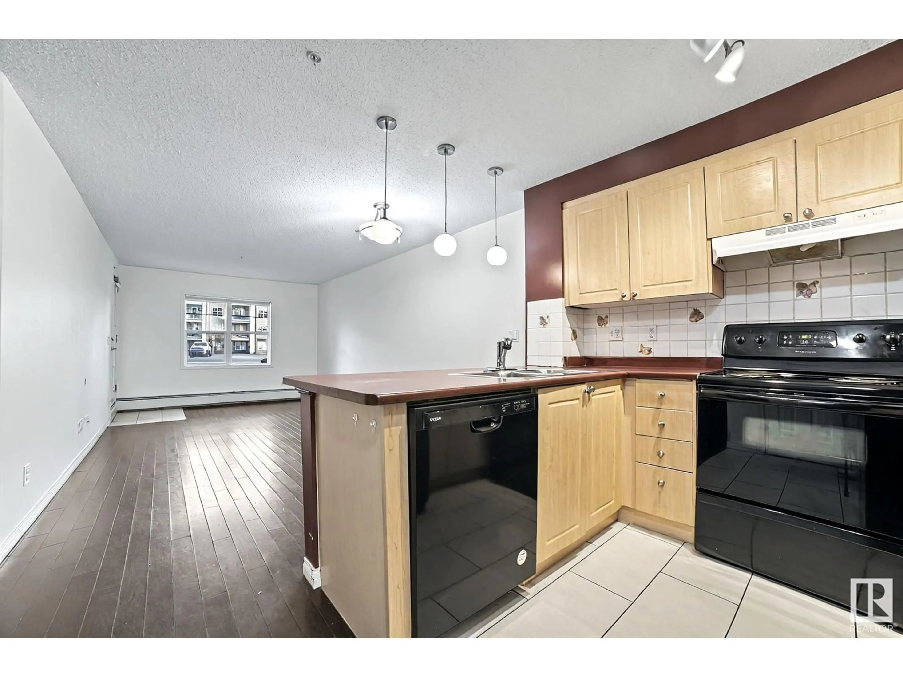 Open concept kitchen, wood/laminate floor for #111 - 622 MCALLISTER LO, Edmonton Alberta T6W1N1