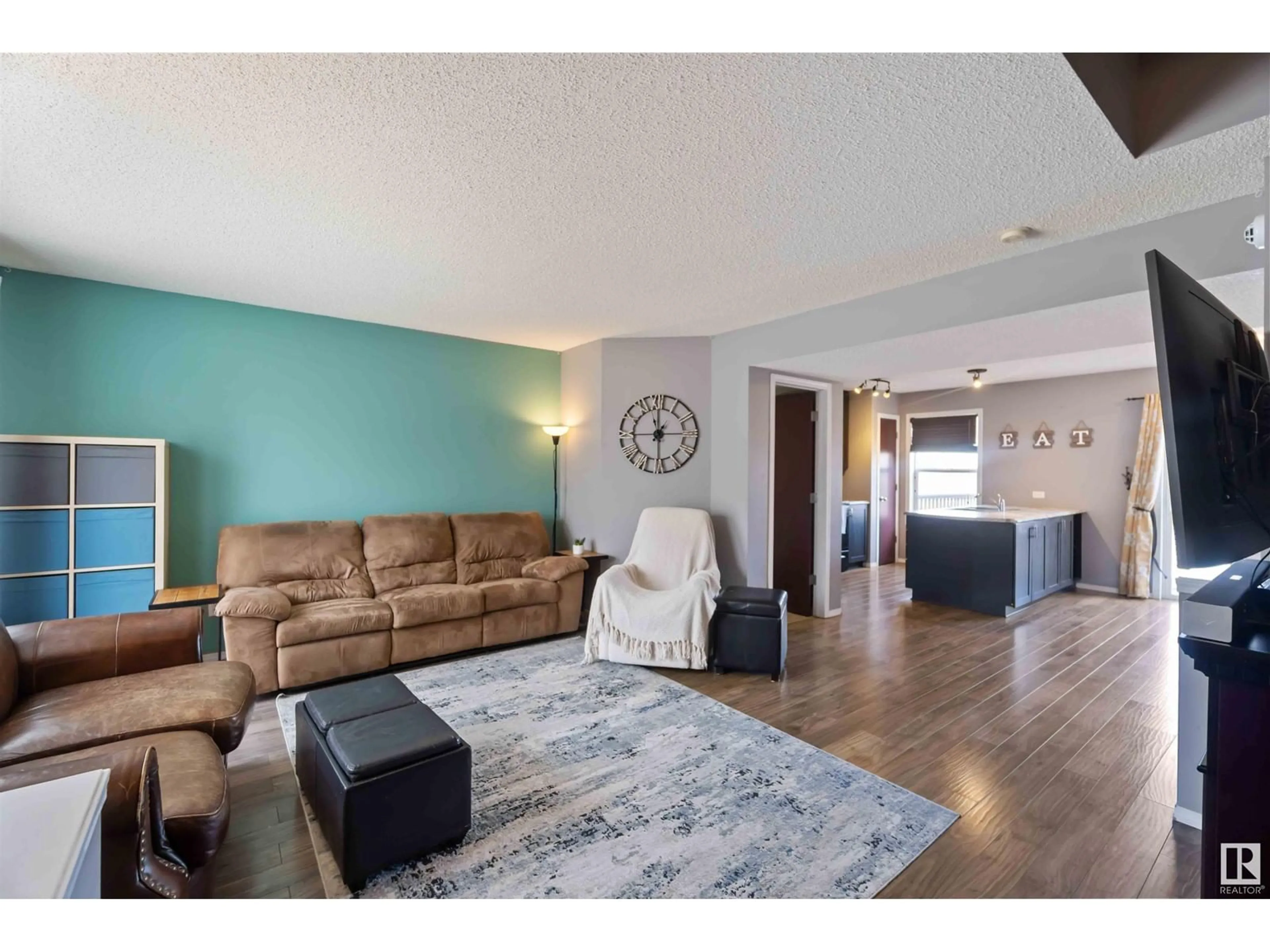 Living room with furniture, wood/laminate floor for SW - 1215 76 ST, Edmonton Alberta T6X1M9