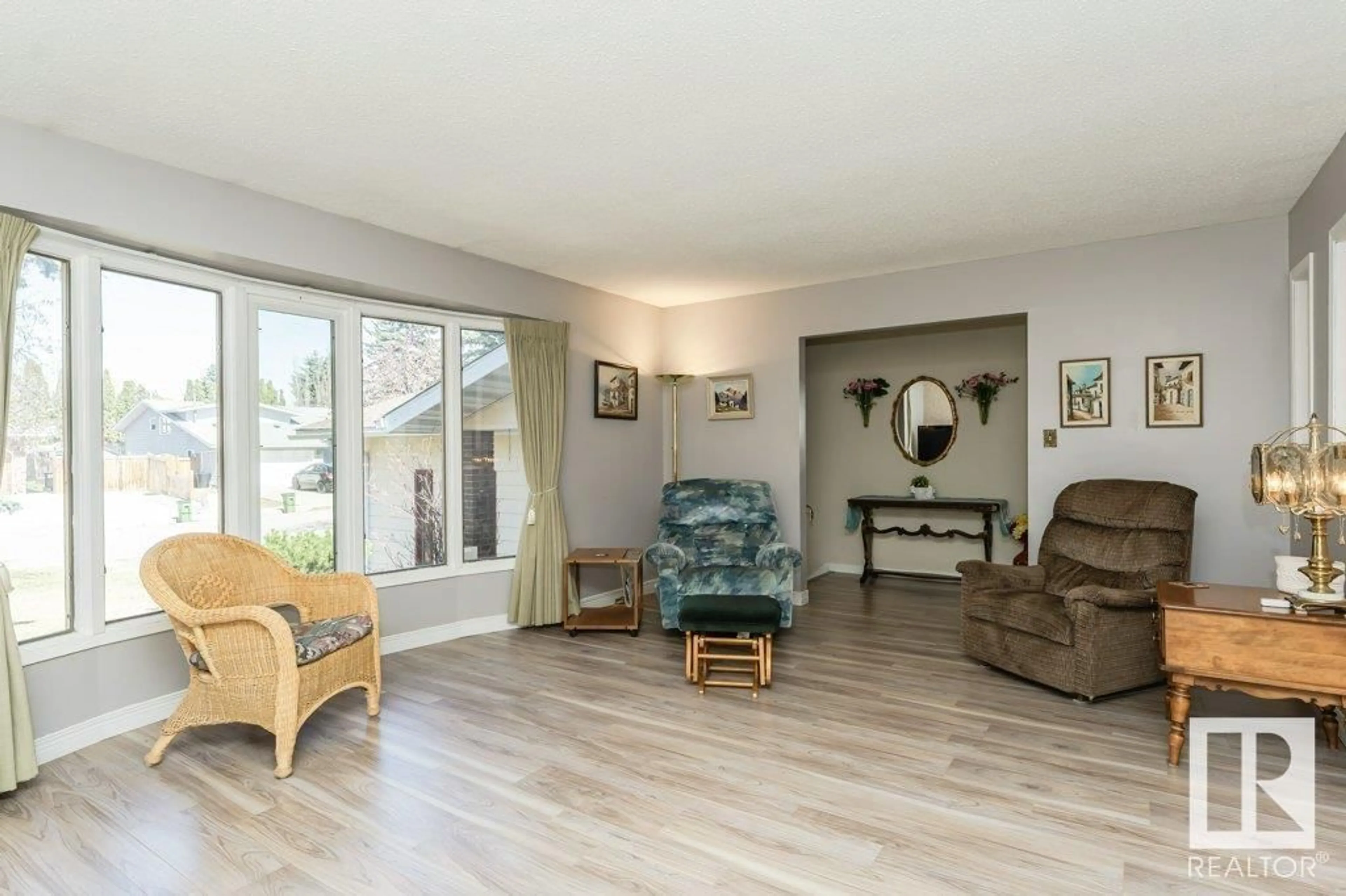 Living room with furniture, wood/laminate floor for NW - 11245 34A AV, Edmonton Alberta T6J3N5